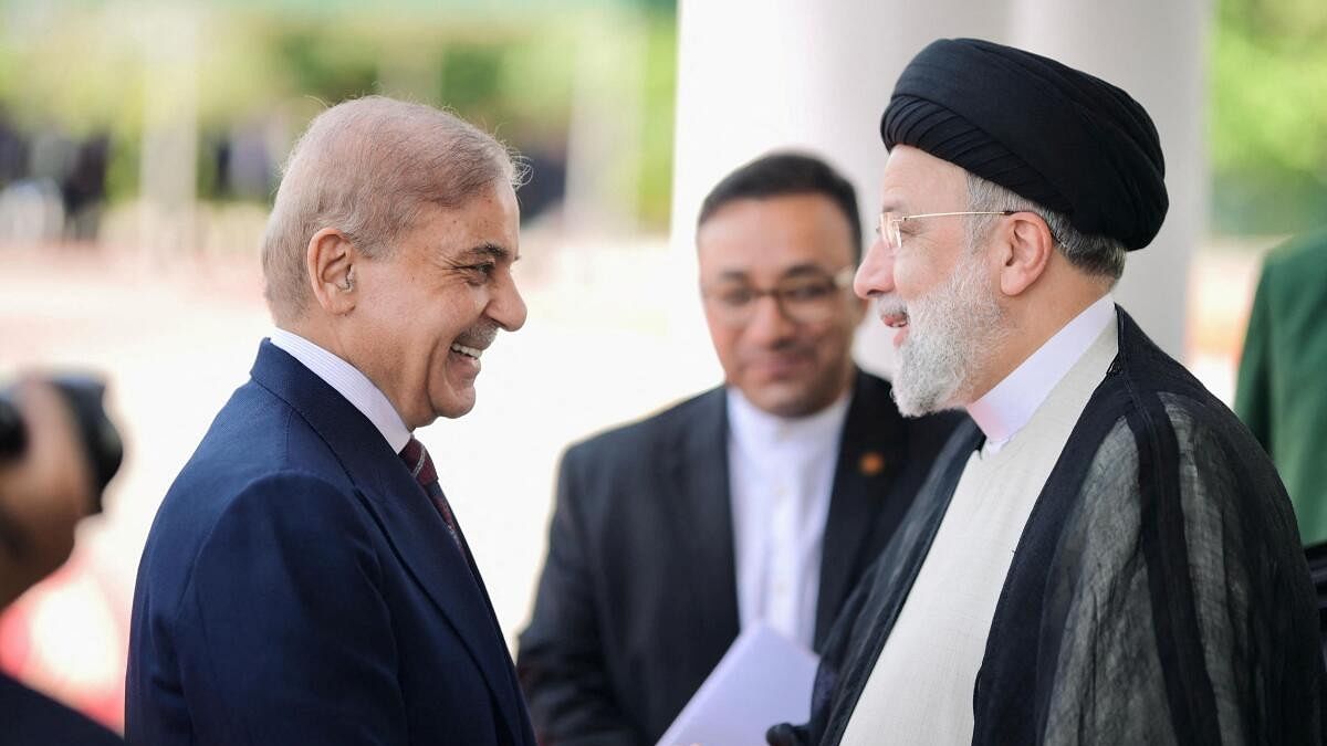<div class="paragraphs"><p>Pakistan's Prime Minister Shehbaz Sharif greets Iranian President Ebrahim Raisi on his three-day official visit in Islamabad.</p></div>