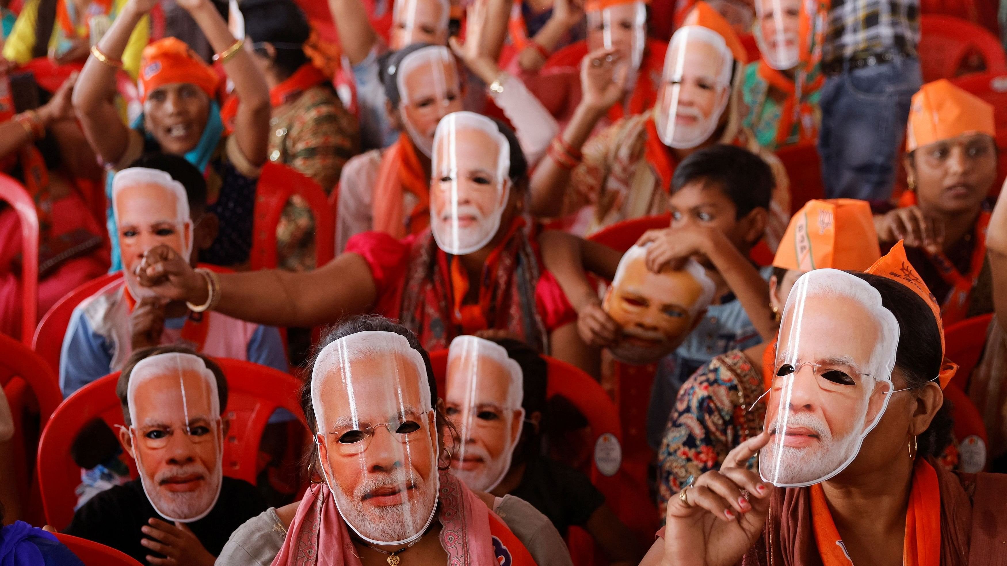 <div class="paragraphs"><p>Supporters of Prime Minister Narendra Modi wear masks of his face.</p></div>