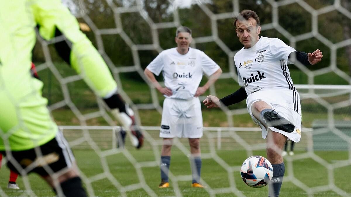 <div class="paragraphs"><p>French President Emmanuel Macron scores a penalty as he participates in the Varietes Club charity football match to benefit children in hospital, in Bernard Giroux stadium in Plaisir, outside Paris</p></div>