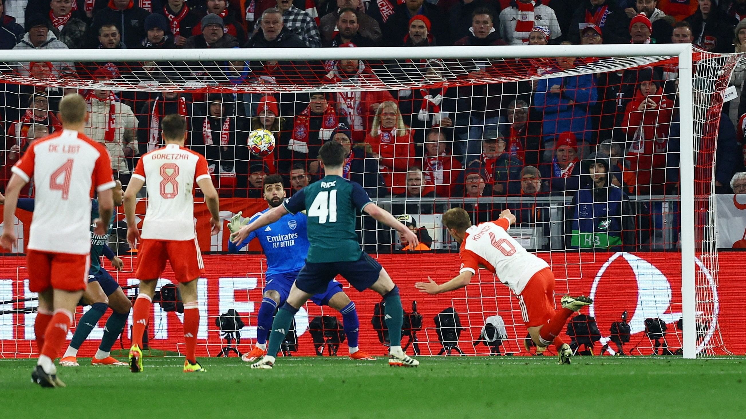 <div class="paragraphs"><p>Bayern Munich's Joshua Kimmich scores their first goal past Arsenal's David Raya </p></div>