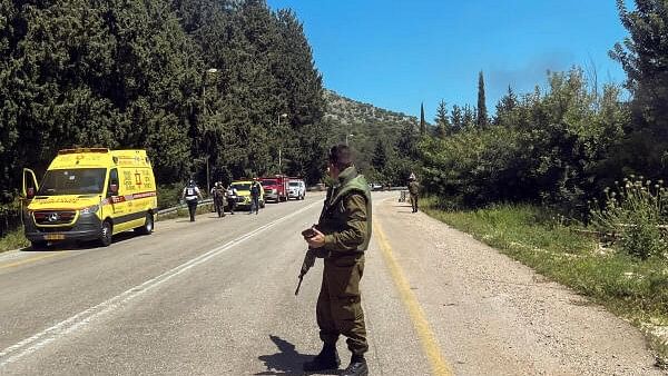 <div class="paragraphs"><p>An Israeli soldier looks on after it was reported that people were injured, amid ongoing cross-border hostilities between Hezbollah and Israeli forces, near Arab al-Aramashe</p></div>