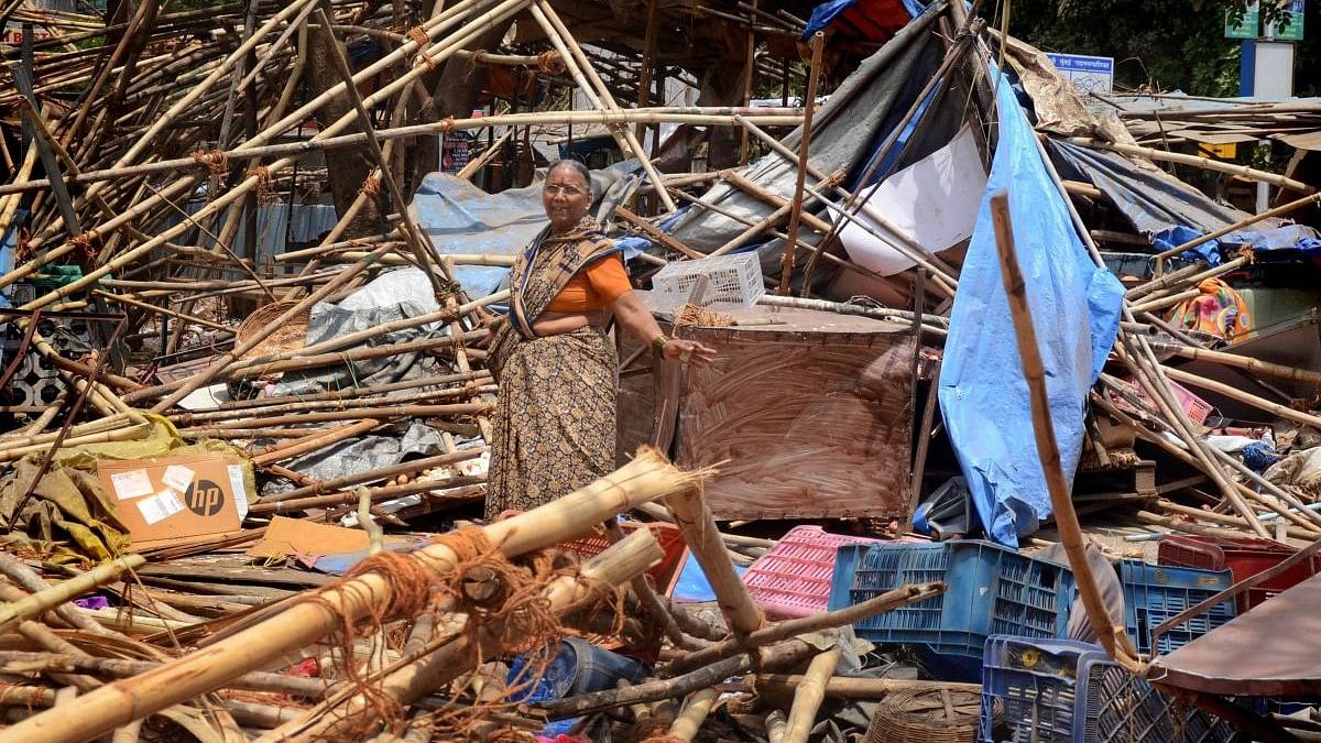 <div class="paragraphs"><p>File photo of a woman standing amid the debris of the temporary shops demolished by Navi Mumbai Municipal Corporation (NMMC) during an anti-encroachment drive against illegal hawkers, at Vashi, in Navi Mumbai.</p></div>