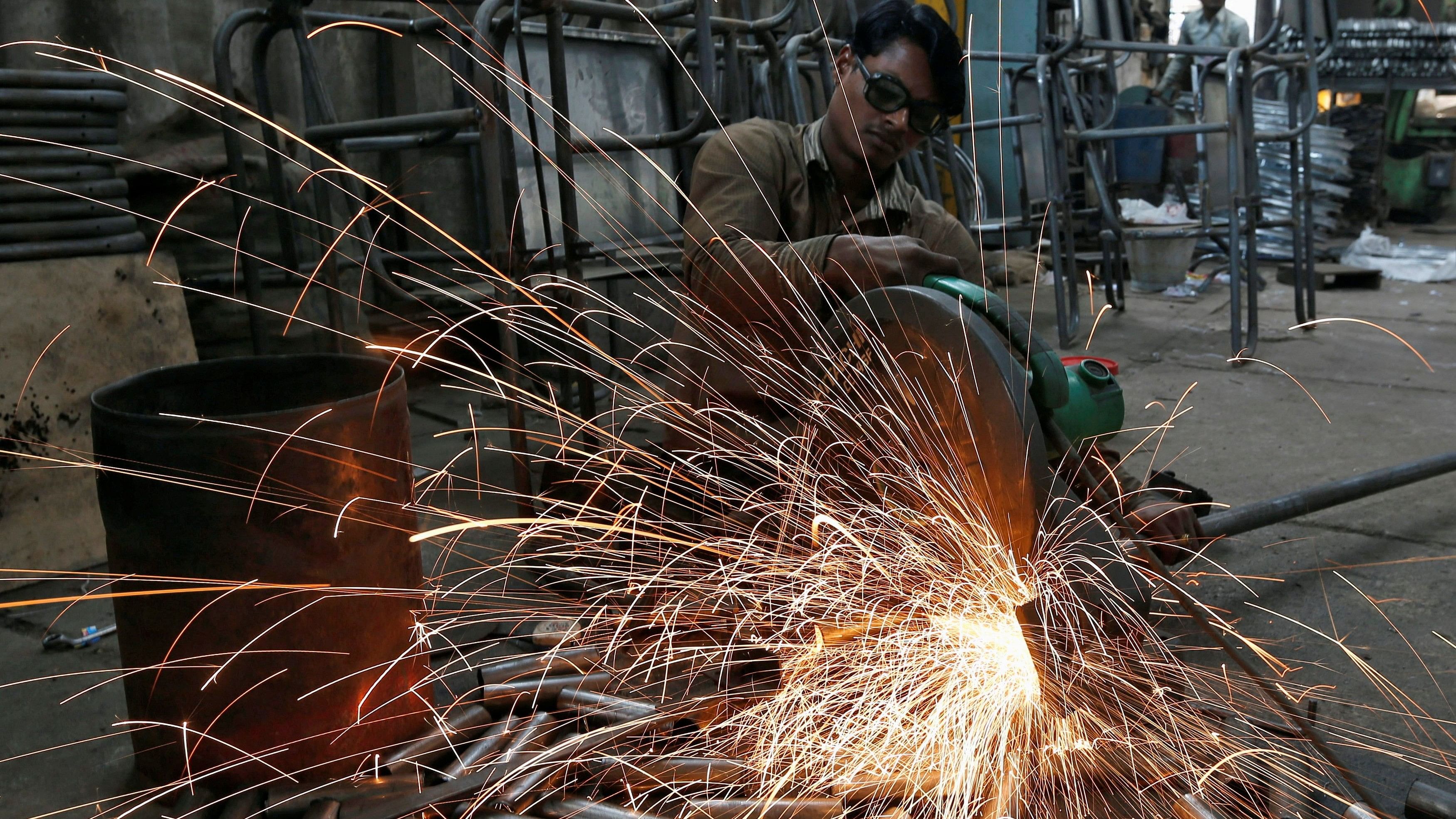 <div class="paragraphs"><p>A worker cuts a metal pipe inside a steel furniture production factory in the western Indian city of Ahmedabad</p></div>