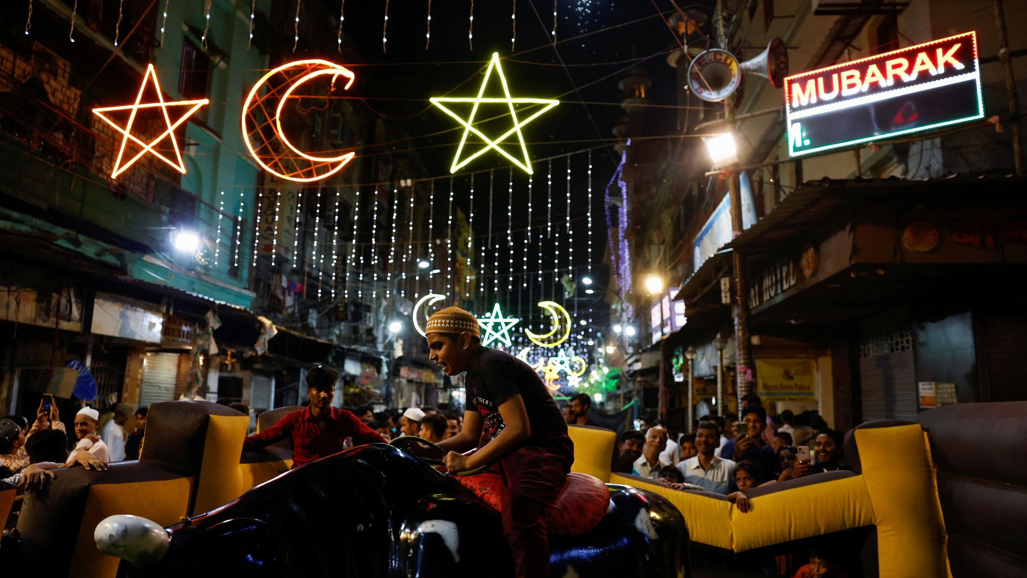 <div class="paragraphs"><p>A boy rides a mechanical bull celebrating the occasion of Eid al-Fitr to mark the end of the holy fasting month of Ramadan on a road in Kolkata, India, April 11, 2024. </p></div>