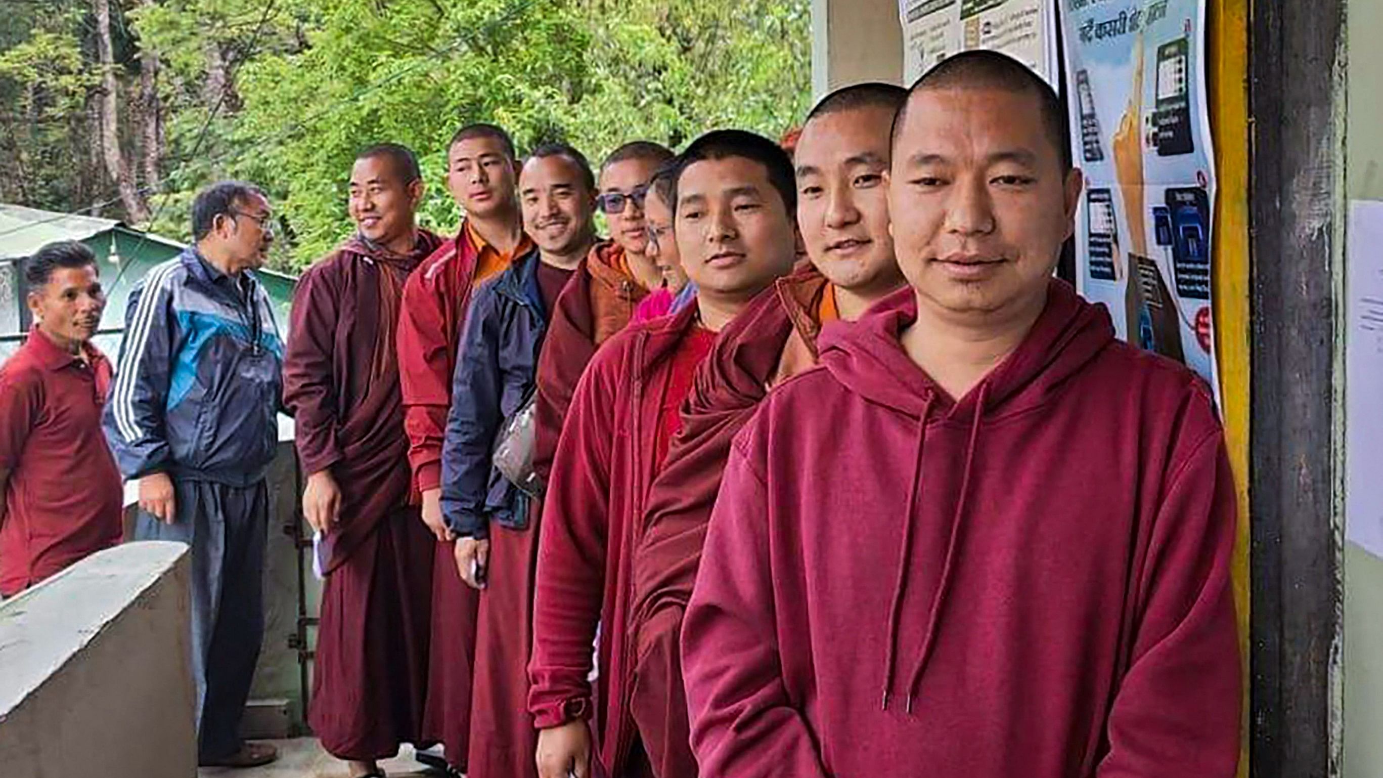 <div class="paragraphs"><p>Monks wait in a queue at a polling station to cast their votes for the first phase of Lok Sabha elections, in Gangtok, Friday, April 19, 2024.</p></div>