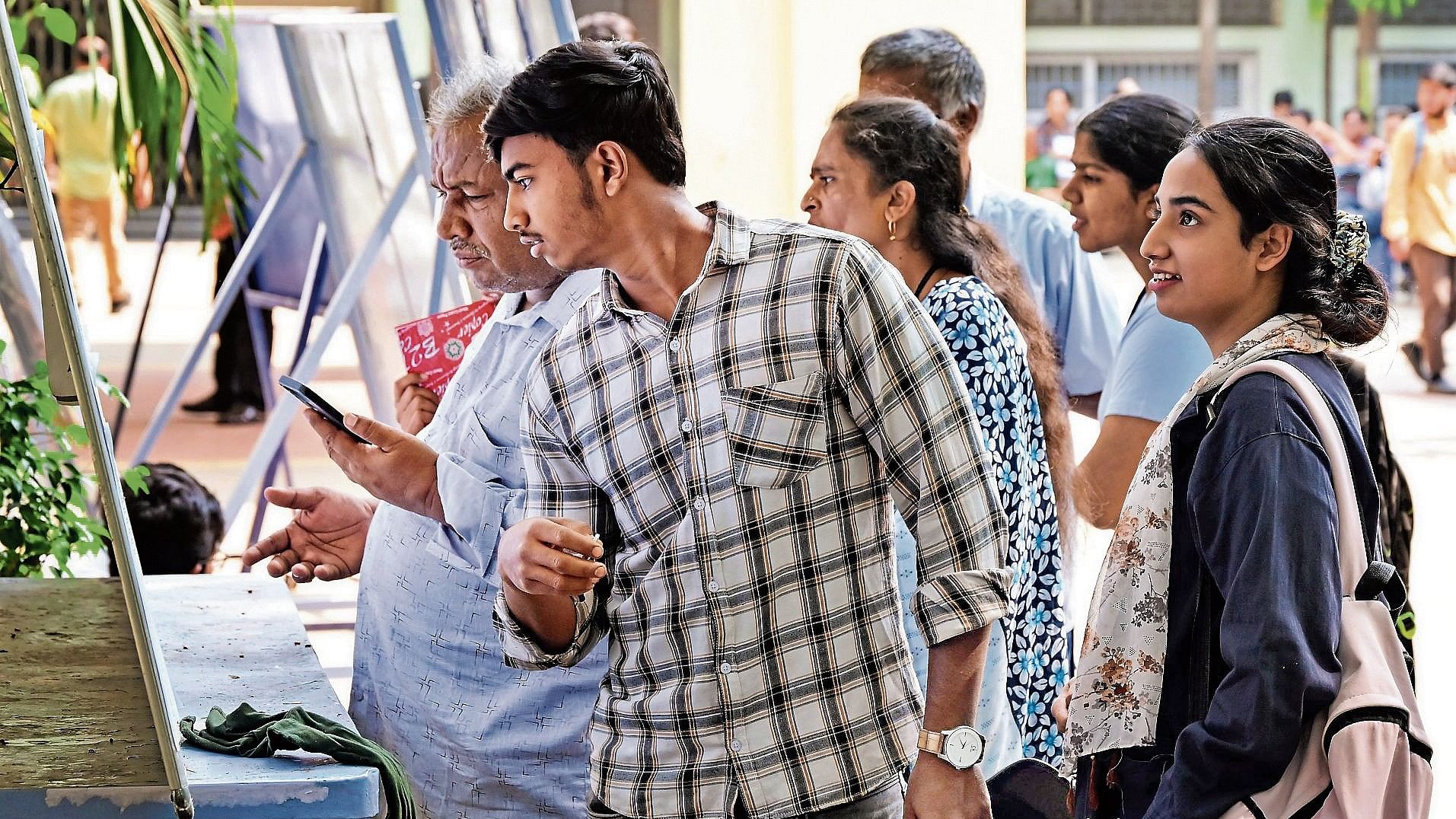 Students check their registration numbers at the National PU College before the KCET exam in Bengaluru on Thursday.