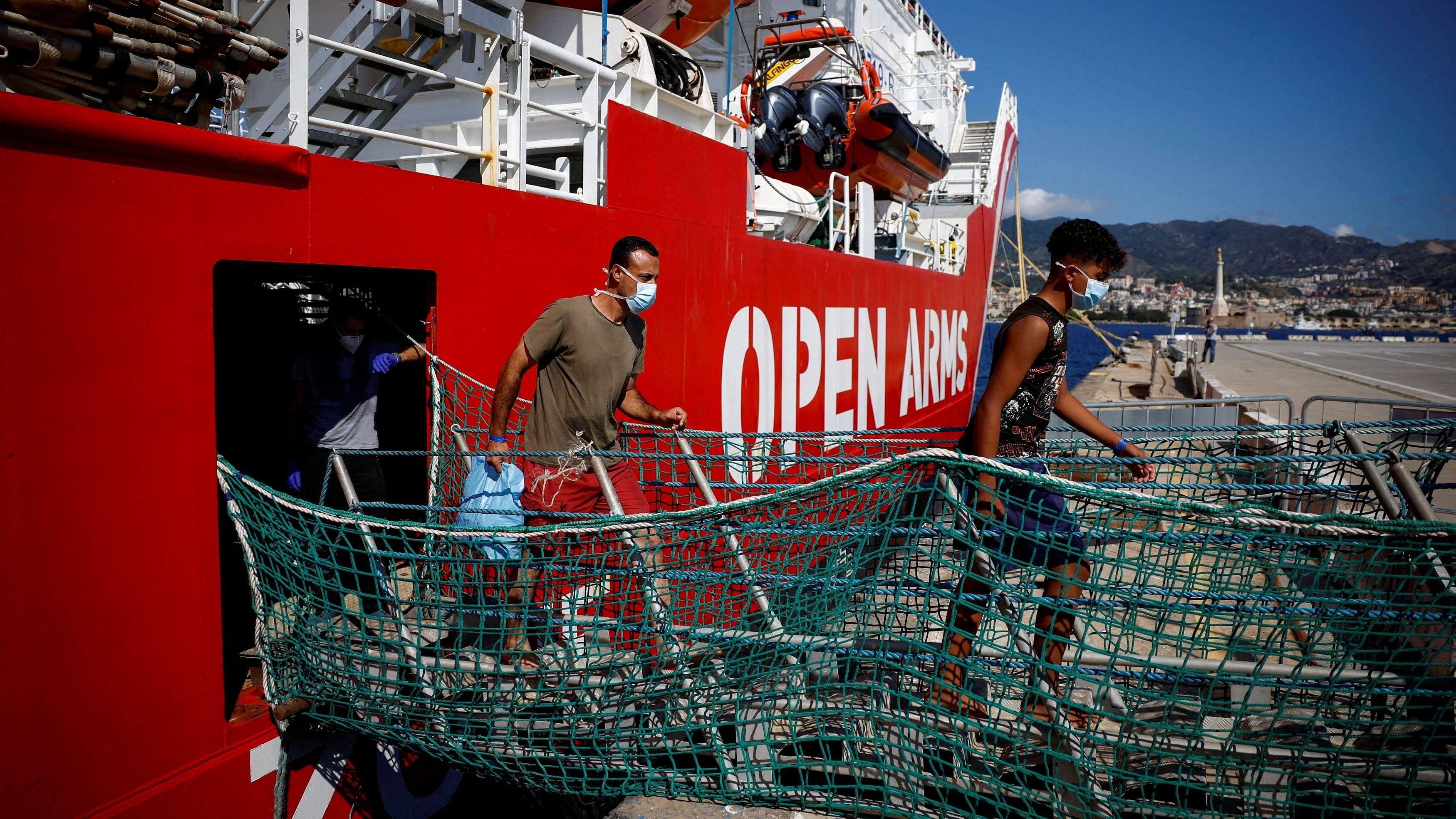 <div class="paragraphs"><p>Migrants disembark from Open Arms rescue boat after arriving at Messina port, Sicily, Italy.</p></div>