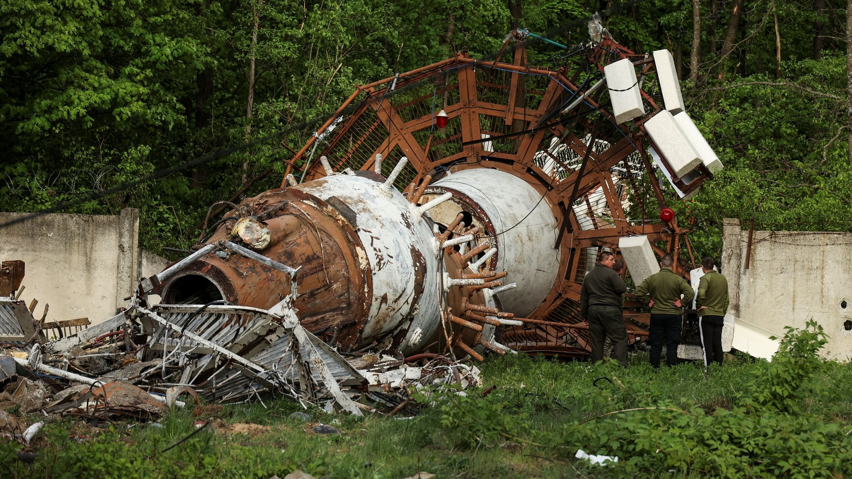 <div class="paragraphs"><p>People stand next to a part of a television tower partially destroyed by a Russian missile strike, amid Russia's attack on Ukraine, in Kharkiv, Ukraine April 22, 2024. </p></div>