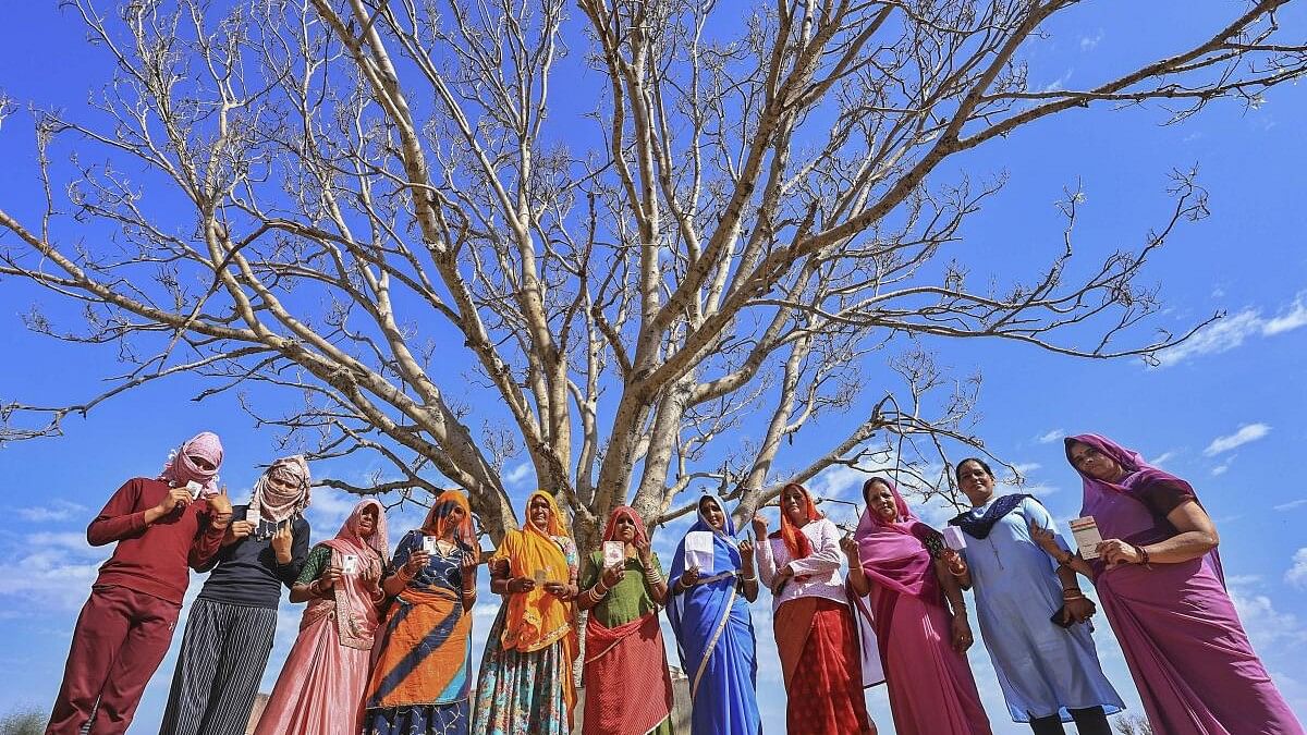 <div class="paragraphs"><p>Jaipur: Women voters show their ink-marked fingers after casting votes for Lok Sabha elections, at Barwada Village in Jaipur, Friday, April 19, 2024. </p></div>