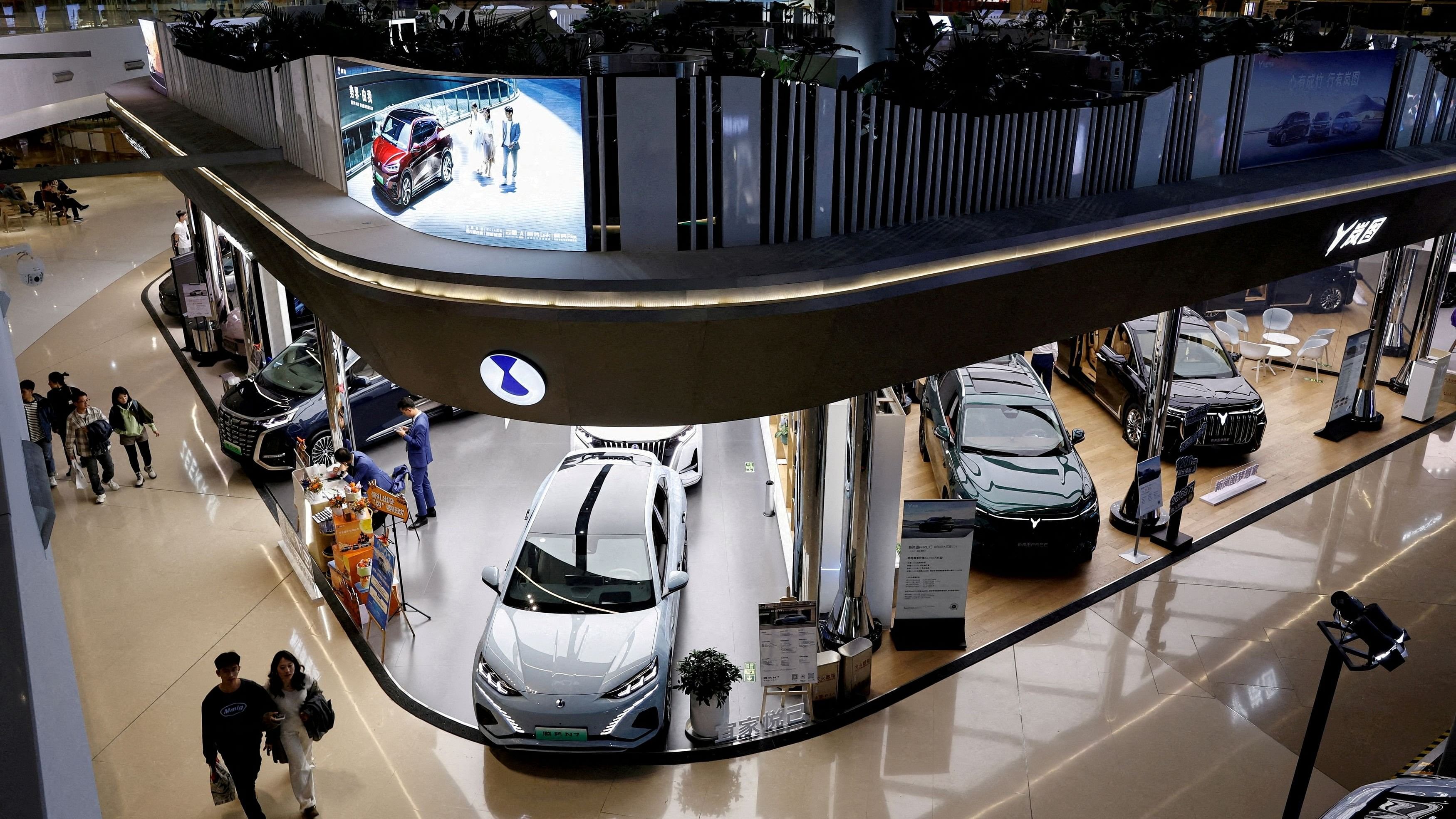 <div class="paragraphs"><p> Electric vehicle  models are displayed at the booths of Denza, a joint venture between Mercedes-Benz Group AG and BYD Auto, and Chinese EV maker Voyah, at a shopping mall in Beijing, China.</p></div>