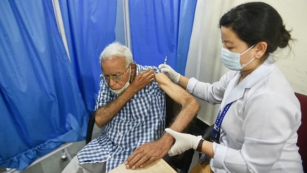 <div class="paragraphs"><p>A health worker administers a dose of Covid preventive vaccine to an elderly man.</p></div>