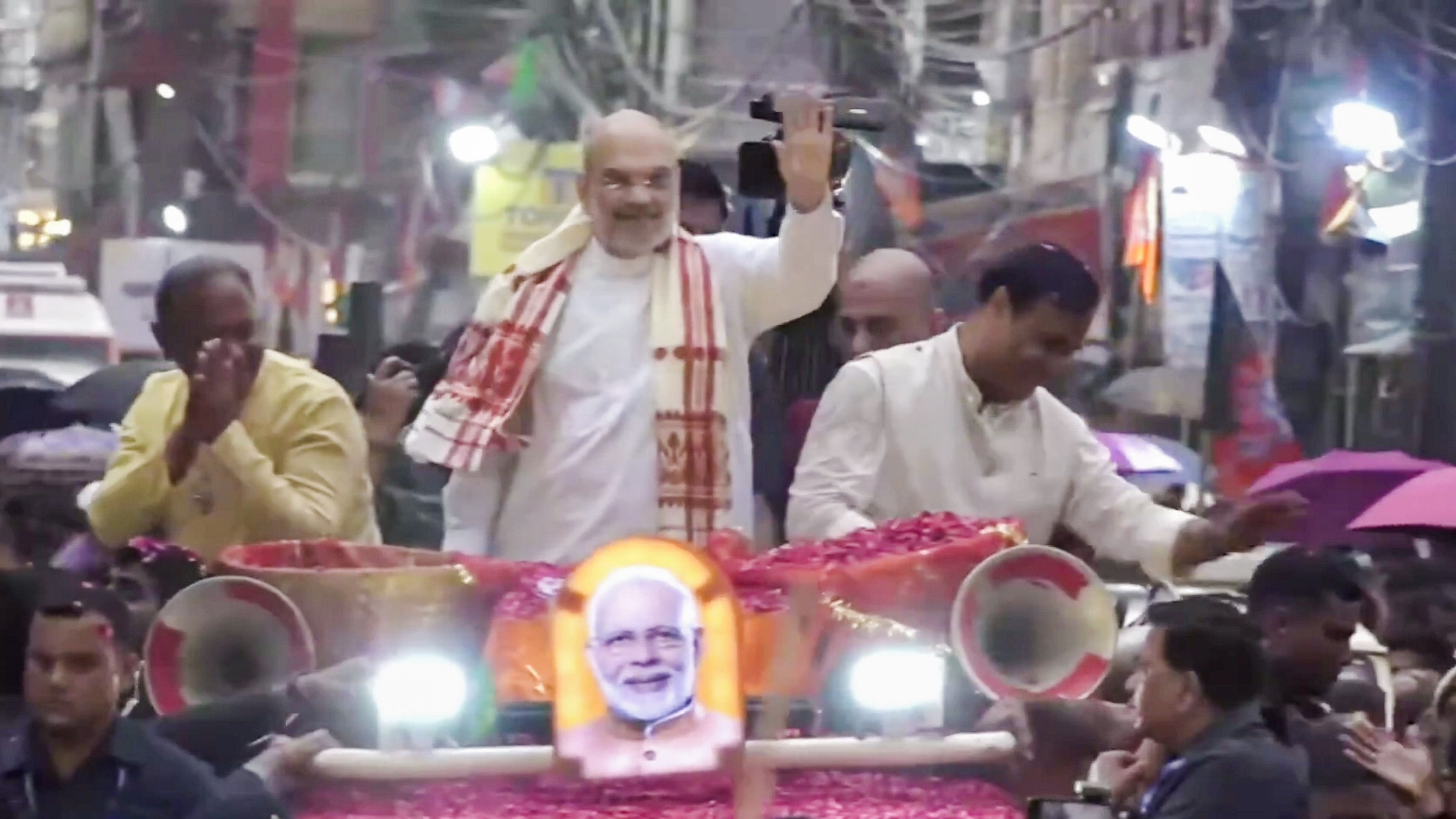 <div class="paragraphs"><p>Home Minister Amit Shah and Assam Chief Minister Himanta Biswa Sarma during a road show for Lok Sabha elections, in Silchar, on Sunday.</p></div>