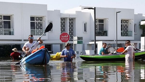 <div class="paragraphs"><p>Residents move their belongings on a kayak at a flooded residential complex following heavy rainfall, in Dubai, United Arab Emirates, April 18, 2024.</p></div>