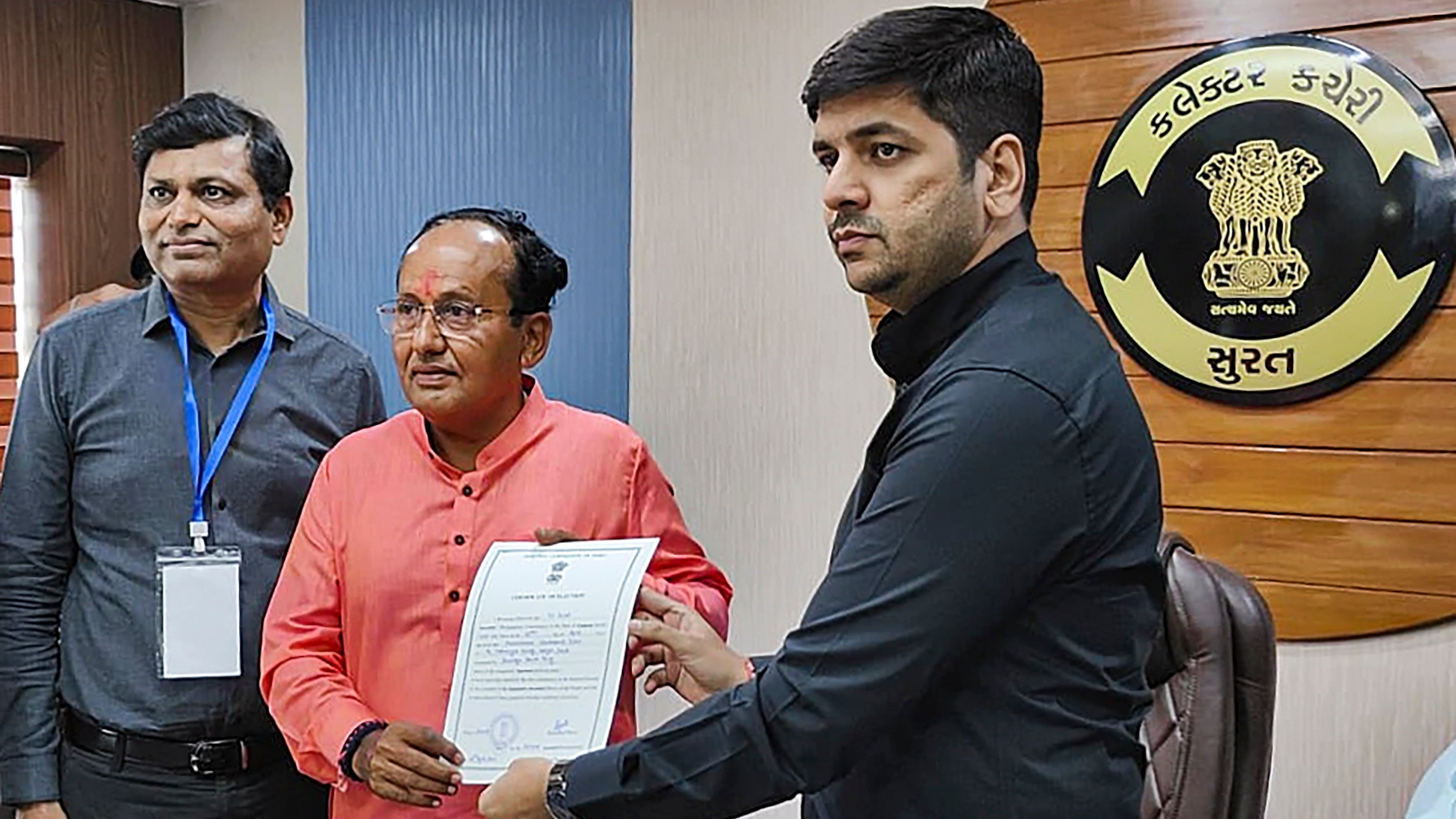 <div class="paragraphs"><p> BJP leader Mukesh Dalal receives the 'certificate of election' after he was elected unopposed from Surat Lok Sabha seat.</p></div>