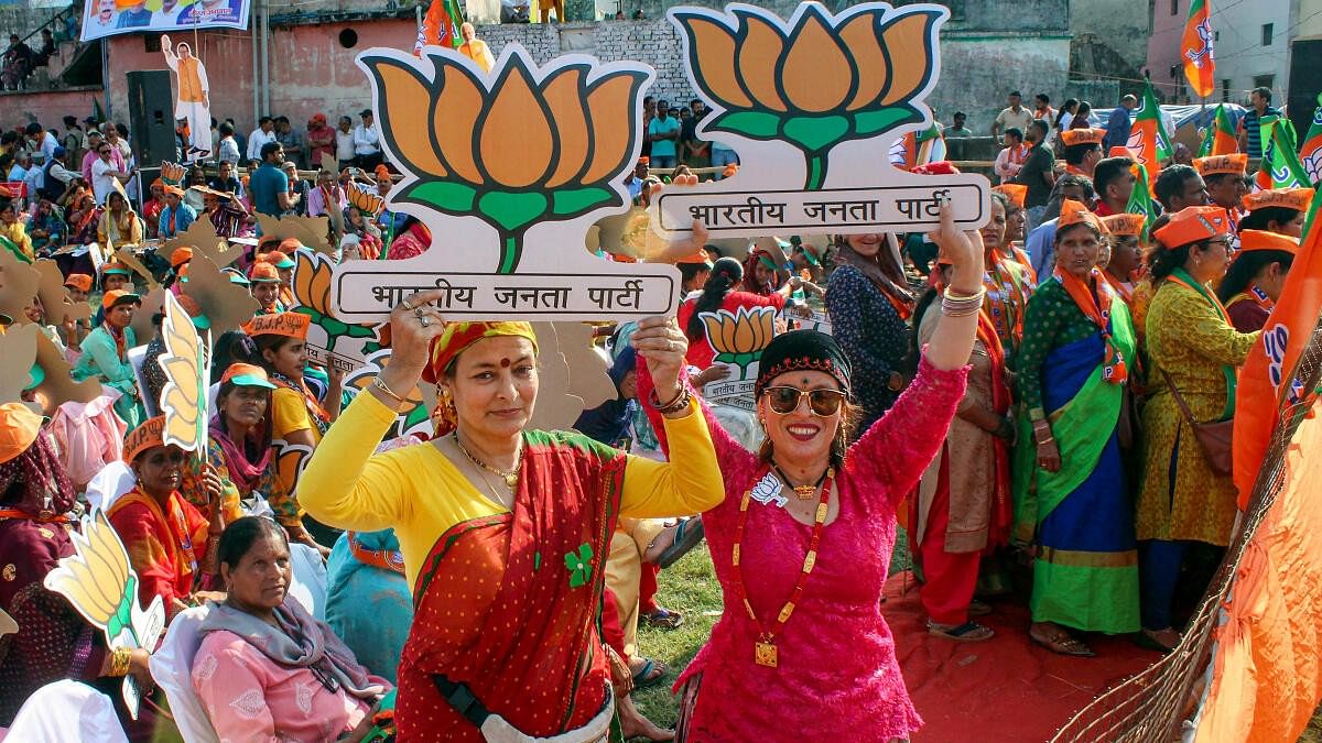 <div class="paragraphs"><p>BJP supporters pose for photos during BJP National President JP Nadda's rally ahead of the upcoming Lok Sabha election.&nbsp;</p></div>