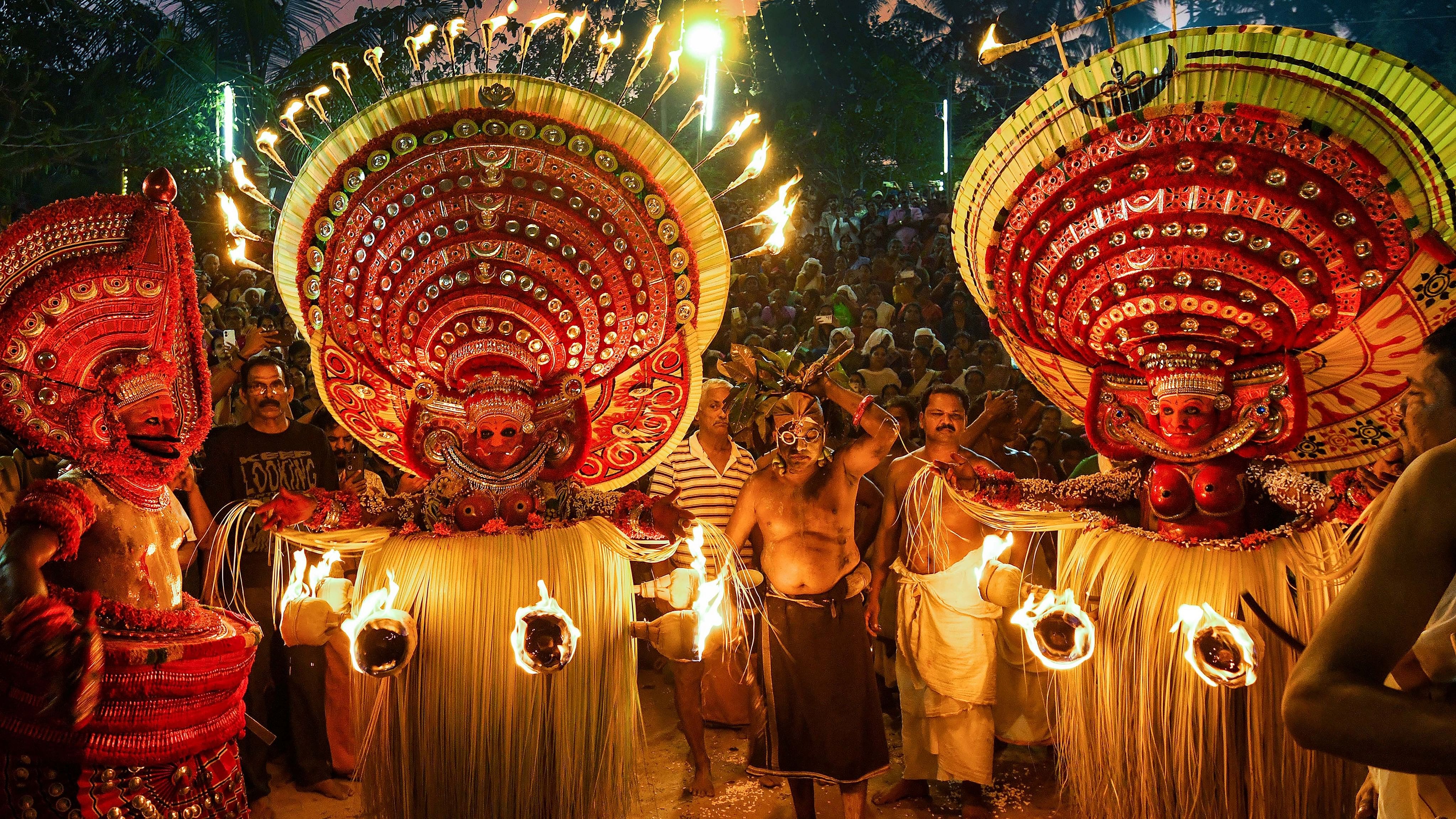 <div class="paragraphs"><p> Theyyam artists perform.</p></div>