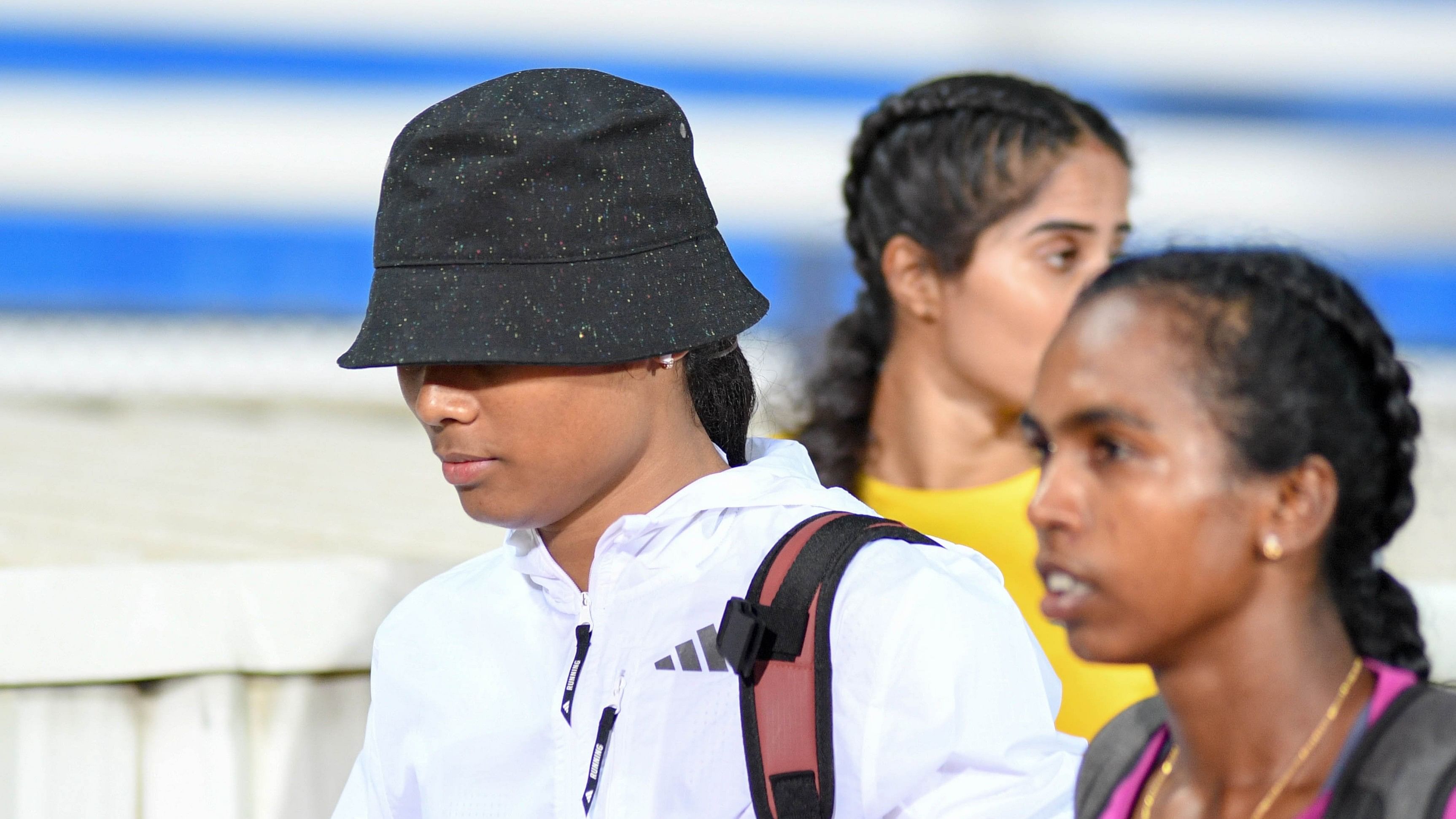 <div class="paragraphs"><p>Assam’s Hima Das (left) walks off after pulling out of the women’s 200m run midway at the Indian Grand Prix-1 at the Sree Kanteerava stadium in Bengaluru on Tuesday. </p></div>