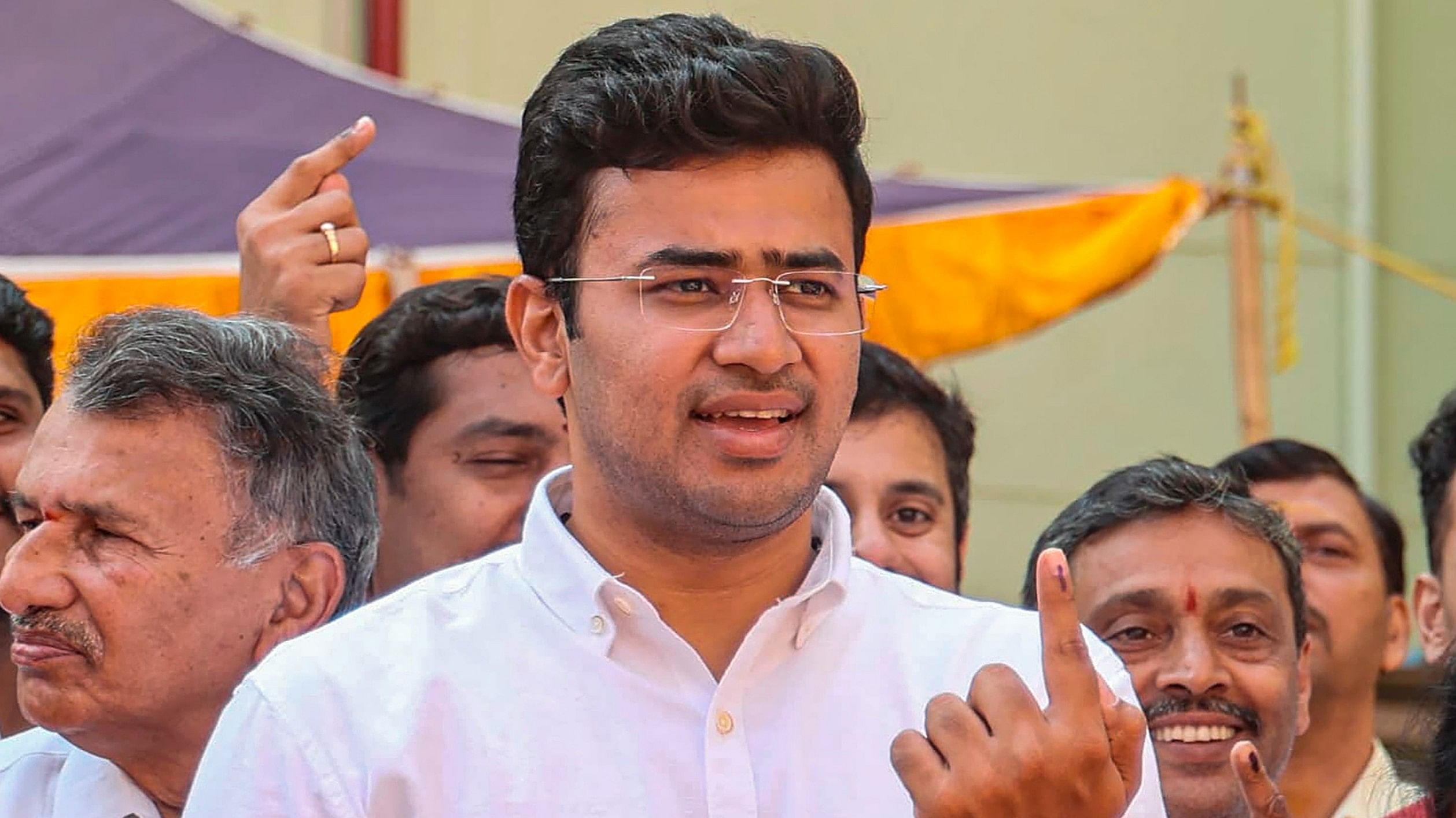 <div class="paragraphs"><p>Bengaluru South constituency BJP candidate Tejasvi Surya shows his finger marked with indelible ink after casting his vote for the 2nd phase of Lok Sabha elections, in Bengaluru, on Friday.</p></div>
