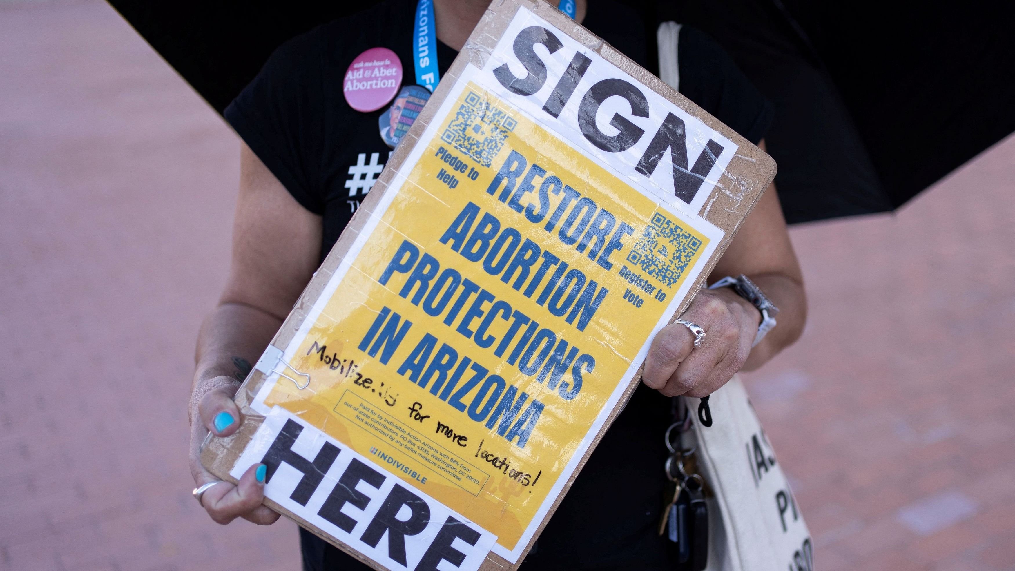 <div class="paragraphs"><p>An organizer carries a clipboard with petitions for a ballot initiative to enshrine abortion into the Arizona state constitution during a small rally led by Women's March Tucson after Arizona's Supreme Court revived a law dating to 1864 that bans abortion in virtually all instances, in Tucson, Arizona, US.</p></div>