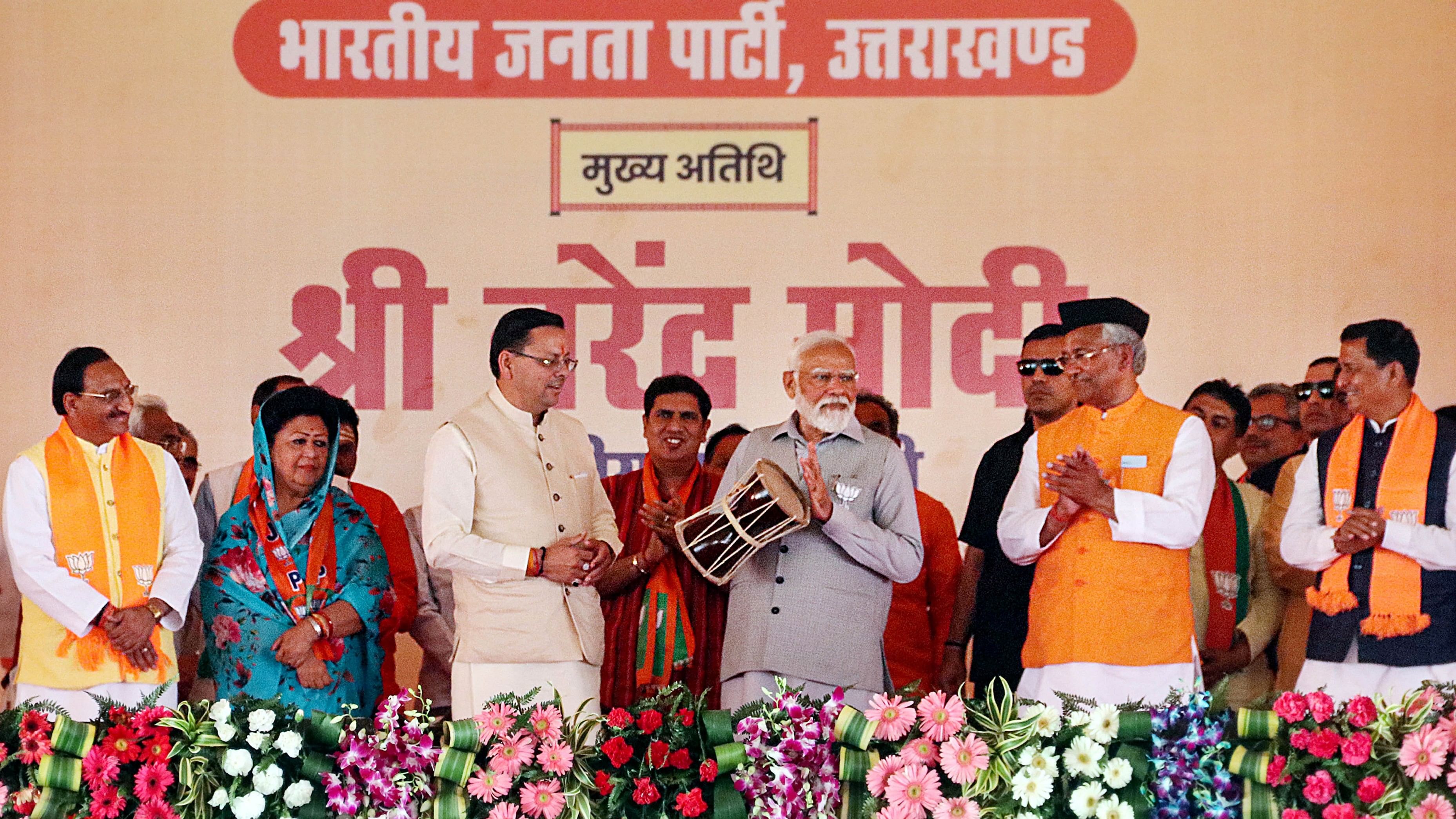 <div class="paragraphs"><p>Prime Minister Narendra Modi with Uttarakhand Chief Minister Pushkar Singh Dhami and other BJP leaders during a public meeting ahead of Lok Sabha elections, in Rishikesh, Thursday, April 11, 2024. </p></div>