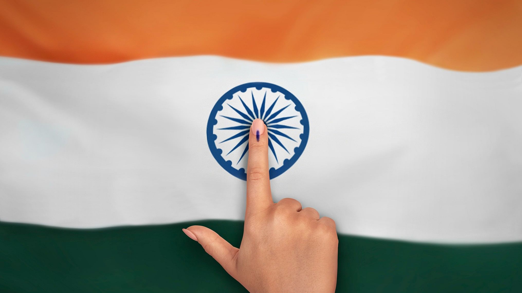 <div class="paragraphs"><p>Voter's hand on the Indian flag.</p></div>