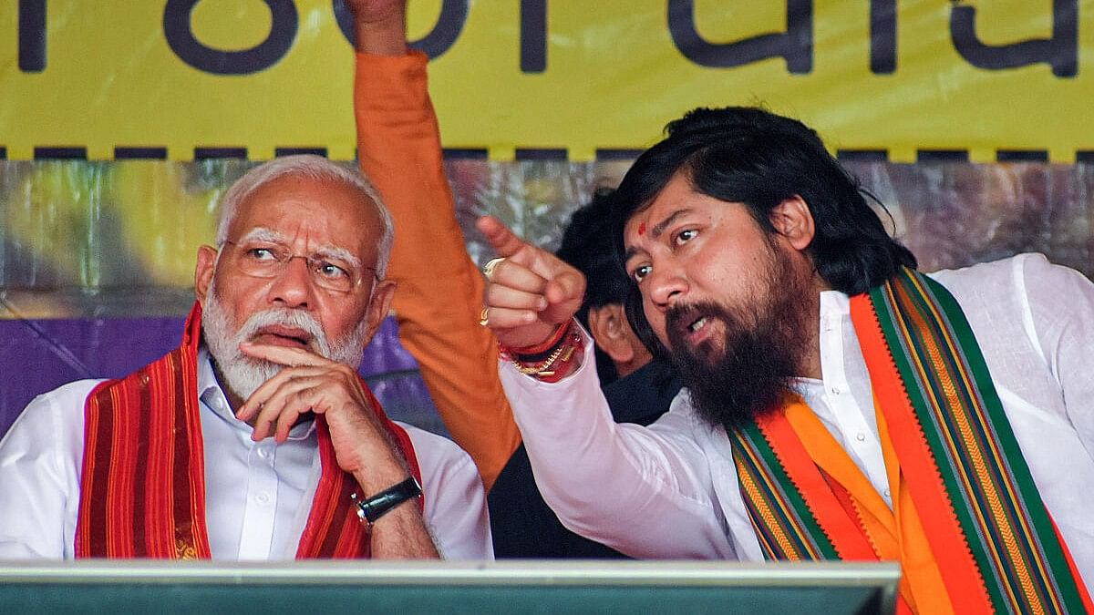 <div class="paragraphs"><p>Prime Minister Narendra Modi with Union Minister and BJP candidate Nisith Pramanik during an election campaign rally ahead of the upcoming Lok Sabha polls, in Cooch Behar district, Thursday, April 4, 2024. </p></div>