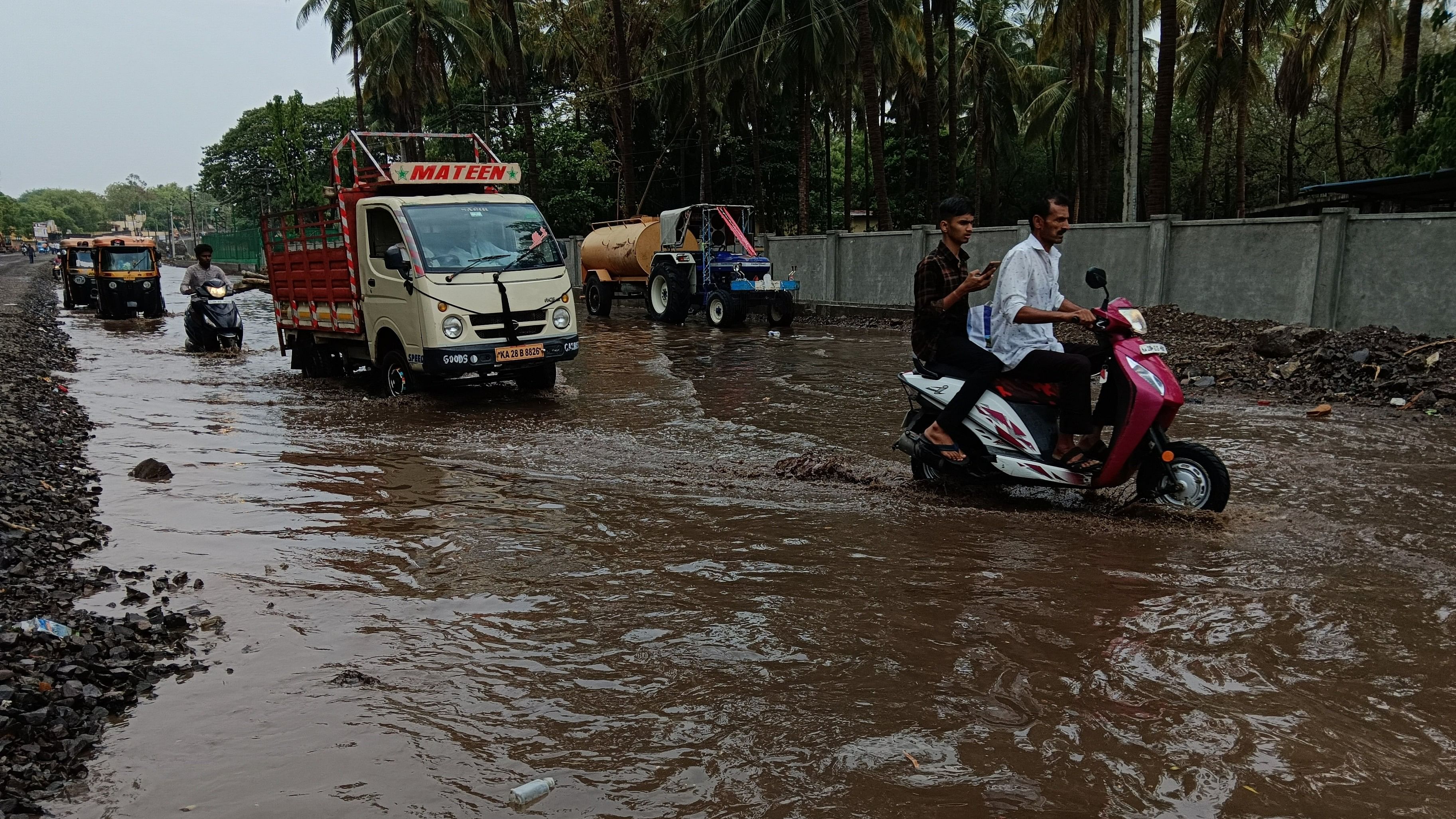 <div class="paragraphs"><p>Motorists navigate a waterlogged road following heavy rain in Vijayapura on Friday. <br><br><br></p></div>