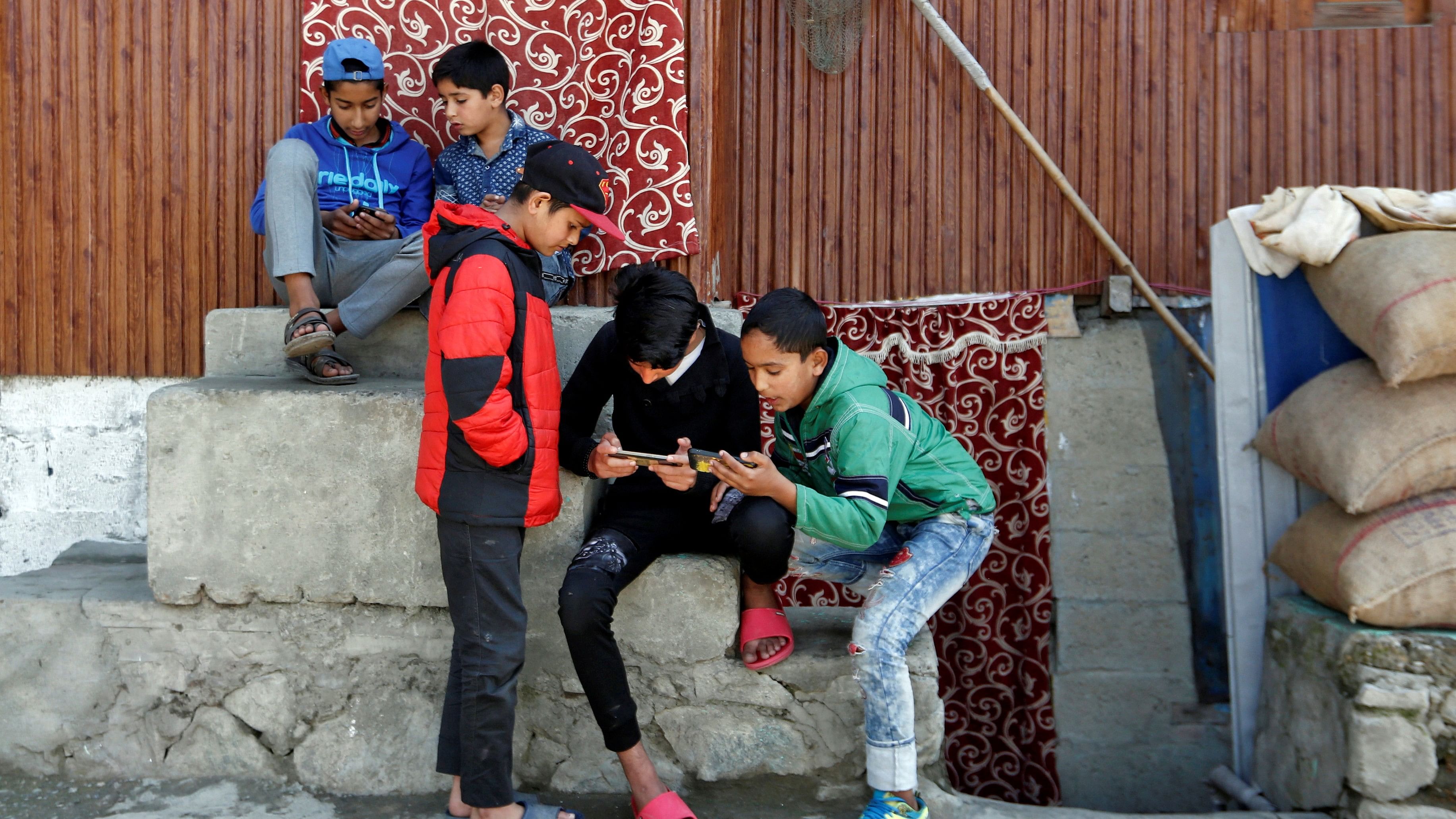 <div class="paragraphs"><p>Children play games on their mobile phones in a neighbourhood in Srinagar (Representational picture)&nbsp;</p></div>