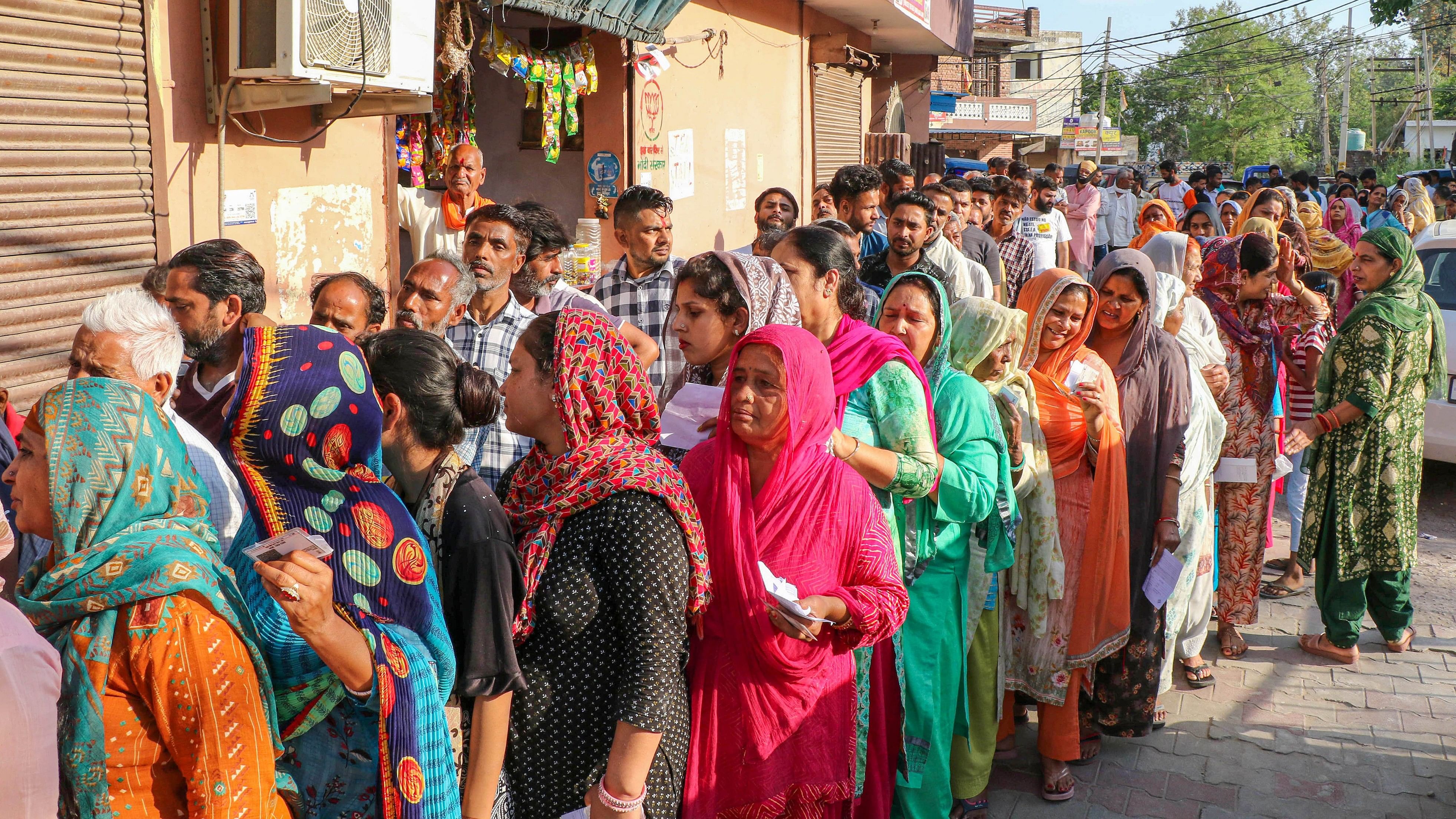 <div class="paragraphs"><p>Voters wait in a queue at a polling station to cast their votes for the 2nd phase of Lok Sabha elections, in Jammu, on Friday.</p></div>