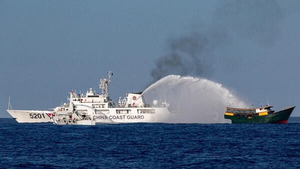 <div class="paragraphs"><p>Chinese Coast Guard vessels fire water cannons towards a Philippine resupply vessel.</p></div>