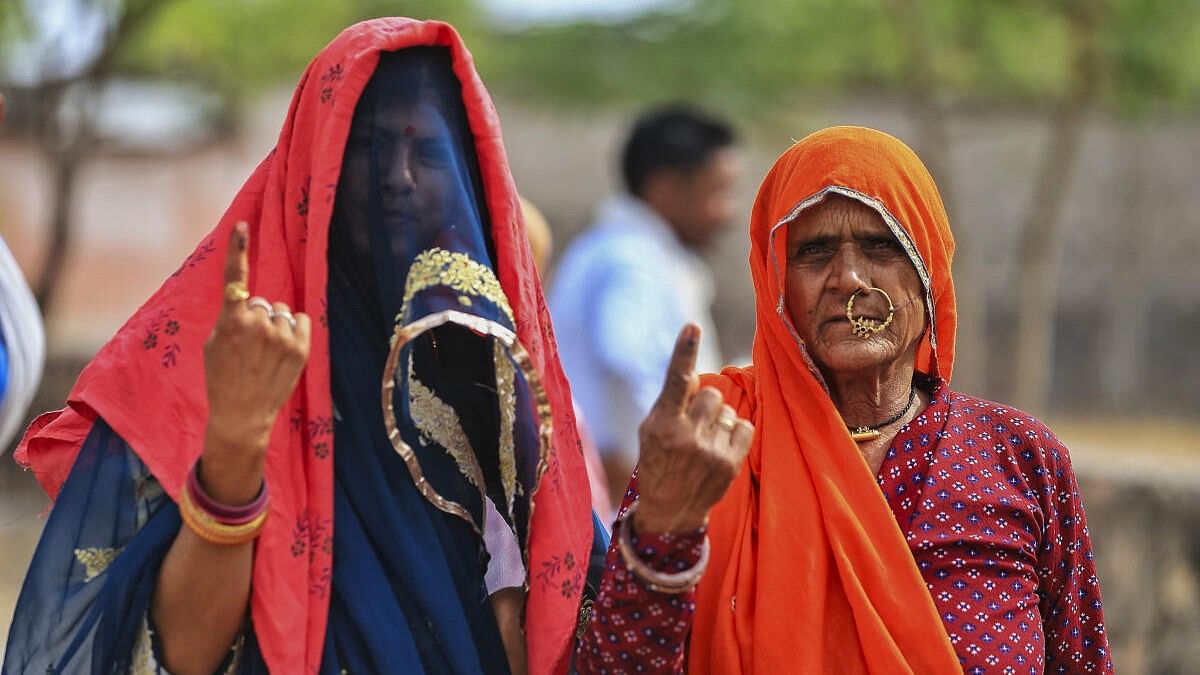 <div class="paragraphs"><p>Women voters show their fingers marked with indelible ink after casting votes during the second phase of Lok Sabha elections, in Dudu district, Rajasthan</p></div>