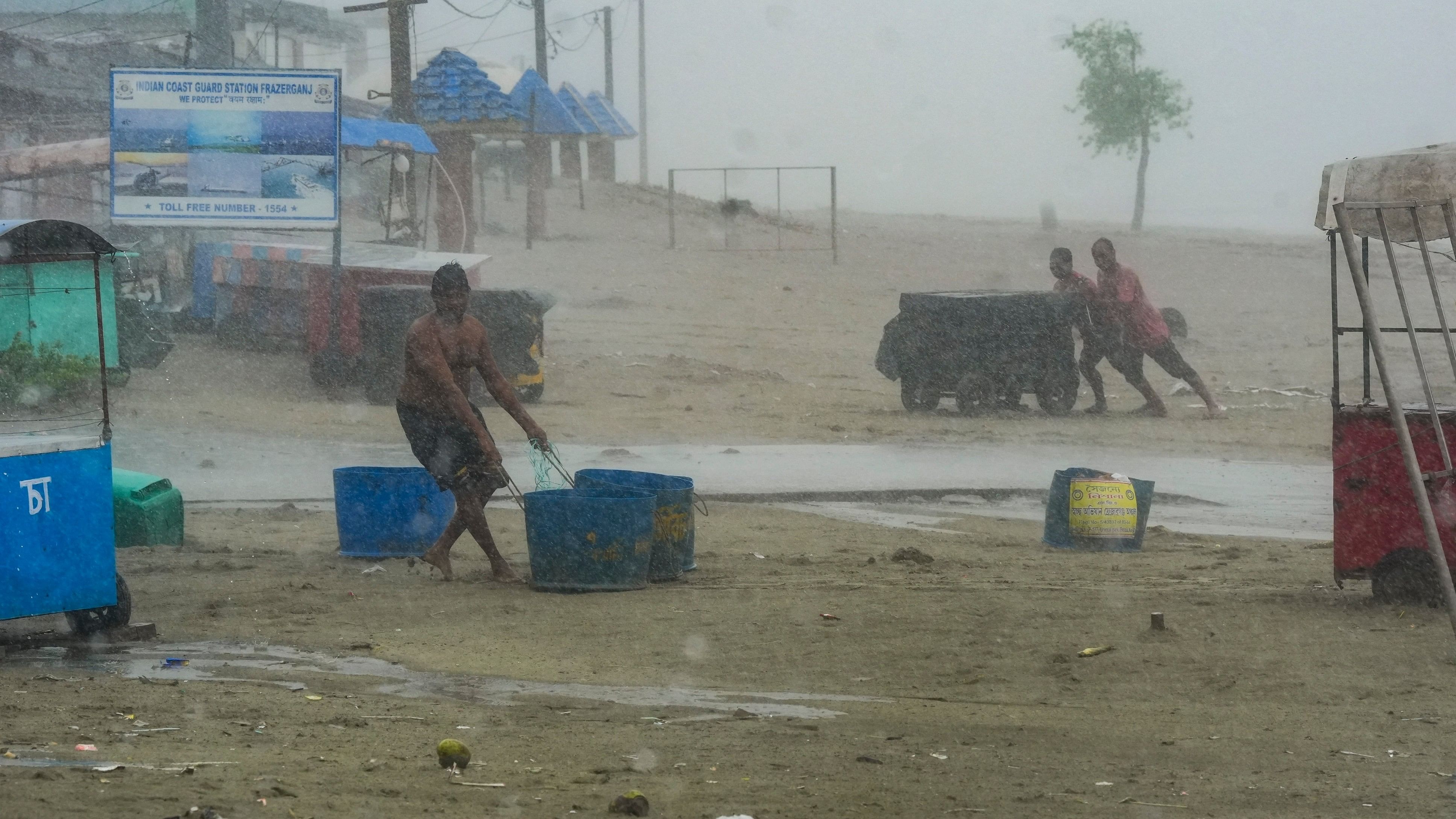 <div class="paragraphs"><p>People move their belongings away from the seashore amid rain, ahead of the landfall of Cyclone 'Remal', in South 24 Parganas district, Sunday, May 26, 2024.</p></div>