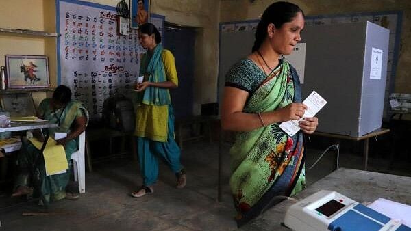 <div class="paragraphs"><p>A woman gets her name checked in a voters' list as other leaves after casting her vote at a polling station  in  Telangana.</p></div>