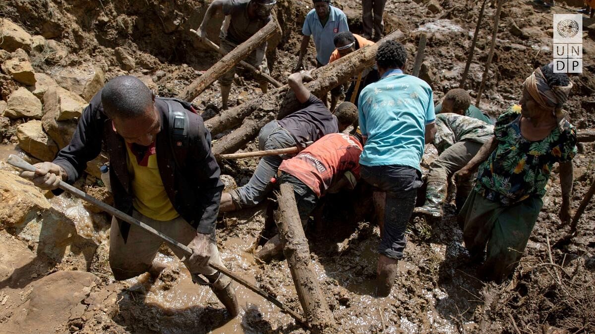 <div class="paragraphs"><p>People clear an area at the site of a landslide in Yambali village, Enga Province, Papua New Guinea.</p></div>