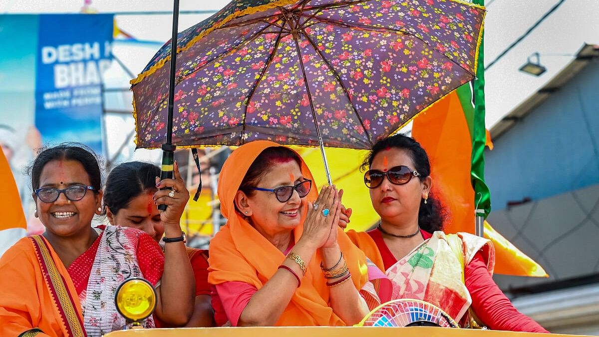 <div class="paragraphs"><p>BJP's Krishnanagar Lok Sabha candidate Amrita Roy takes protection against the scorching sun as she campaigns for Lok Sabha polls, in Nadia</p></div>