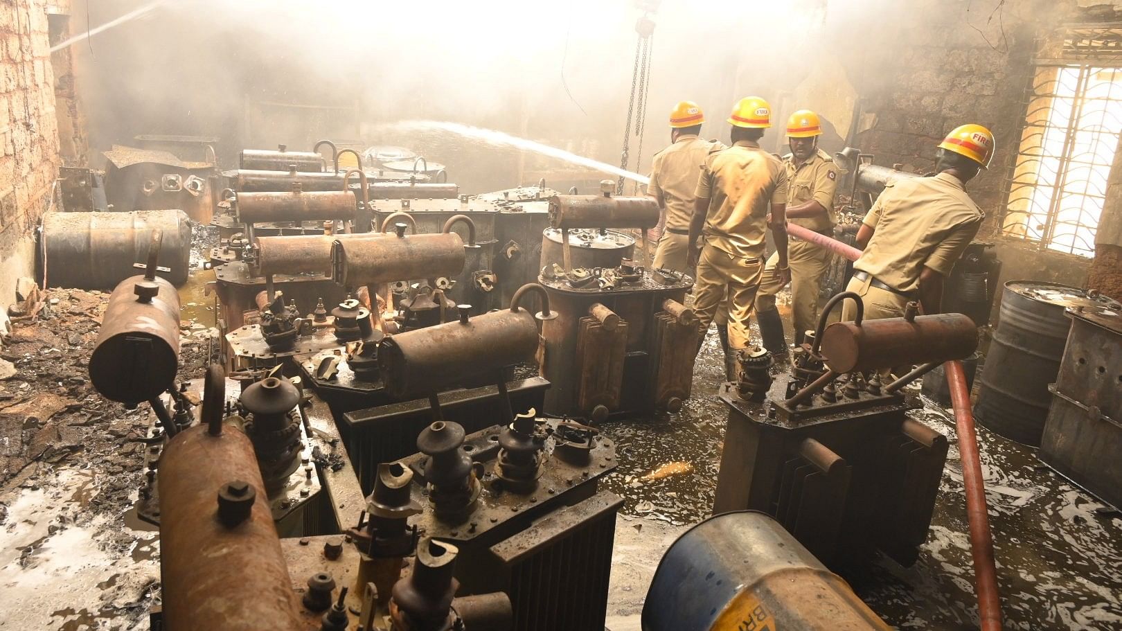 <div class="paragraphs"><p>Firefighters douse the fire that broke out at the transformer repair center of Gescom office in Bidar on Sunday.</p></div>