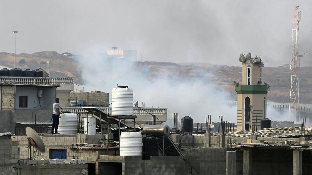 <div class="paragraphs"><p>A man looks on as smoke rises following Israeli strikes during an Israeli military operation in Rafah, in the southern Gaza Strip.</p></div>