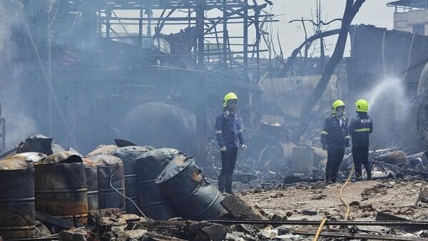 <div class="paragraphs"><p>Firemen sprinkle water inside the chemical factory area at Dombivli.</p></div>