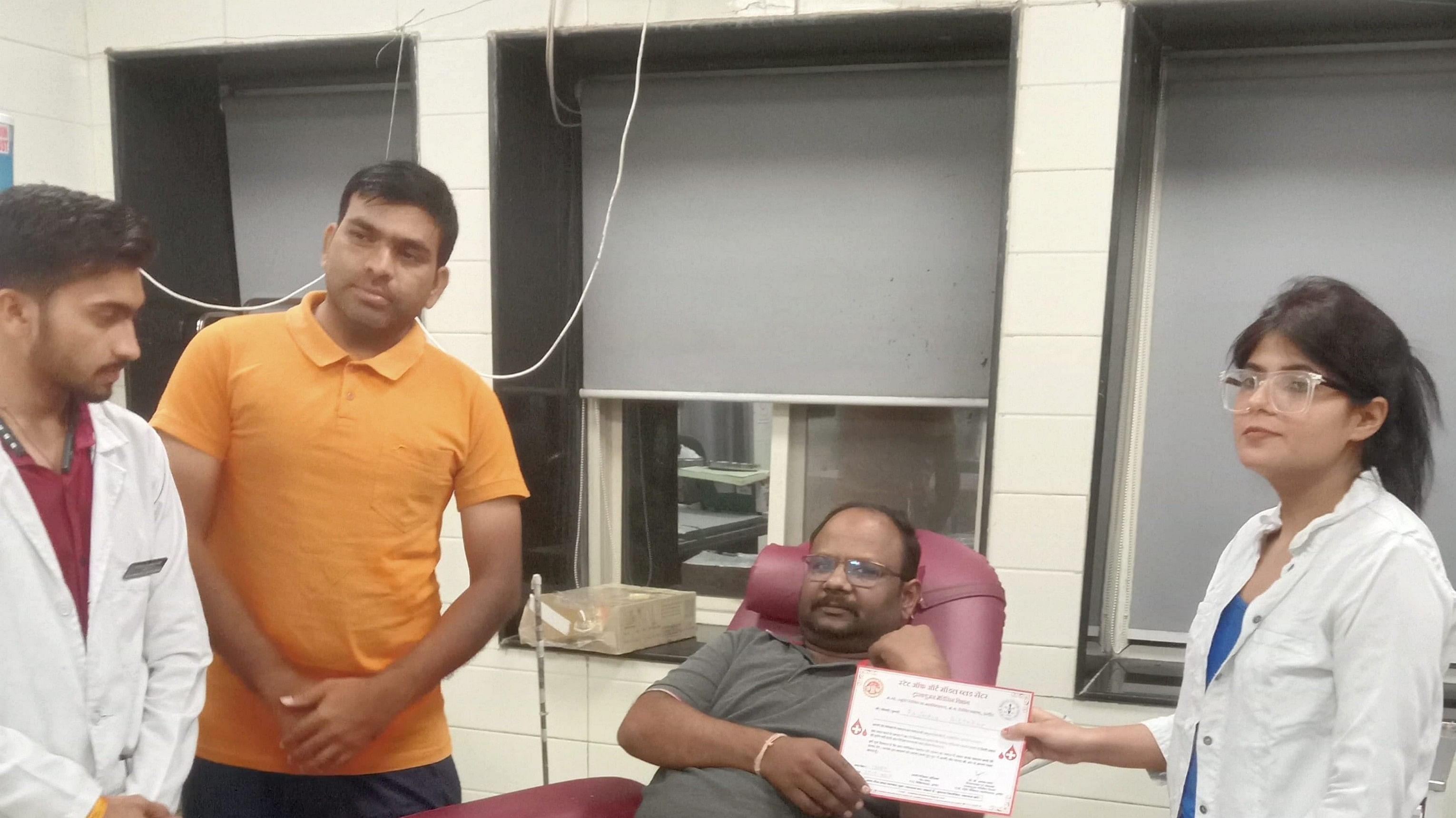 <div class="paragraphs"><p> Ravindra Ashtekar, a Shirdi resident, receives certificate after donating blood of a very rare 'Bombay' group at a hospital, in Indore.</p></div>