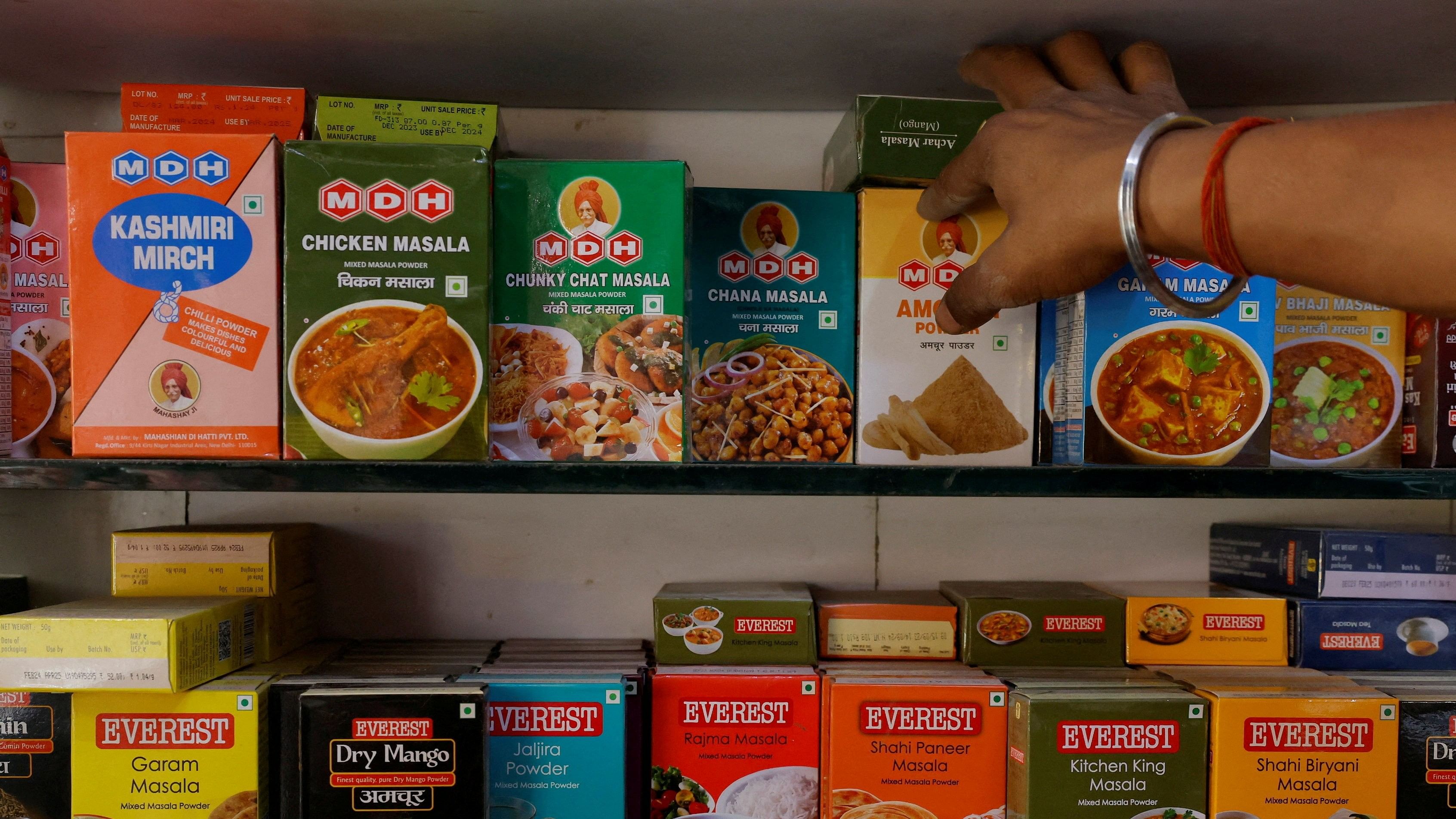 <div class="paragraphs"><p> A man adjusts the spice boxes of MDH and Everest on the shelf of a shop at a market in New Delhi.</p></div>