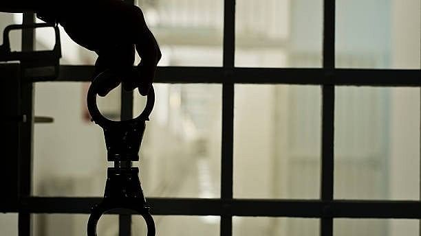 <div class="paragraphs"><p>Representative image showing handcuffs and a prison cell.</p></div>