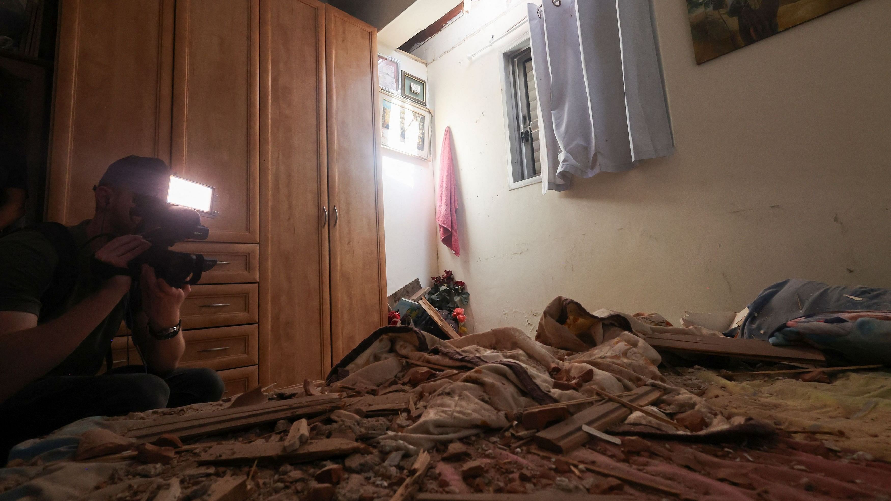 <div class="paragraphs"><p>A media person works in a room that was damaged after rockets were fired from the Gaza Strip towards Israel, amid the ongoing conflict in Gaza between Israel and Palestinian Islamist group Hamas, in Herzliya, Israel.</p></div>