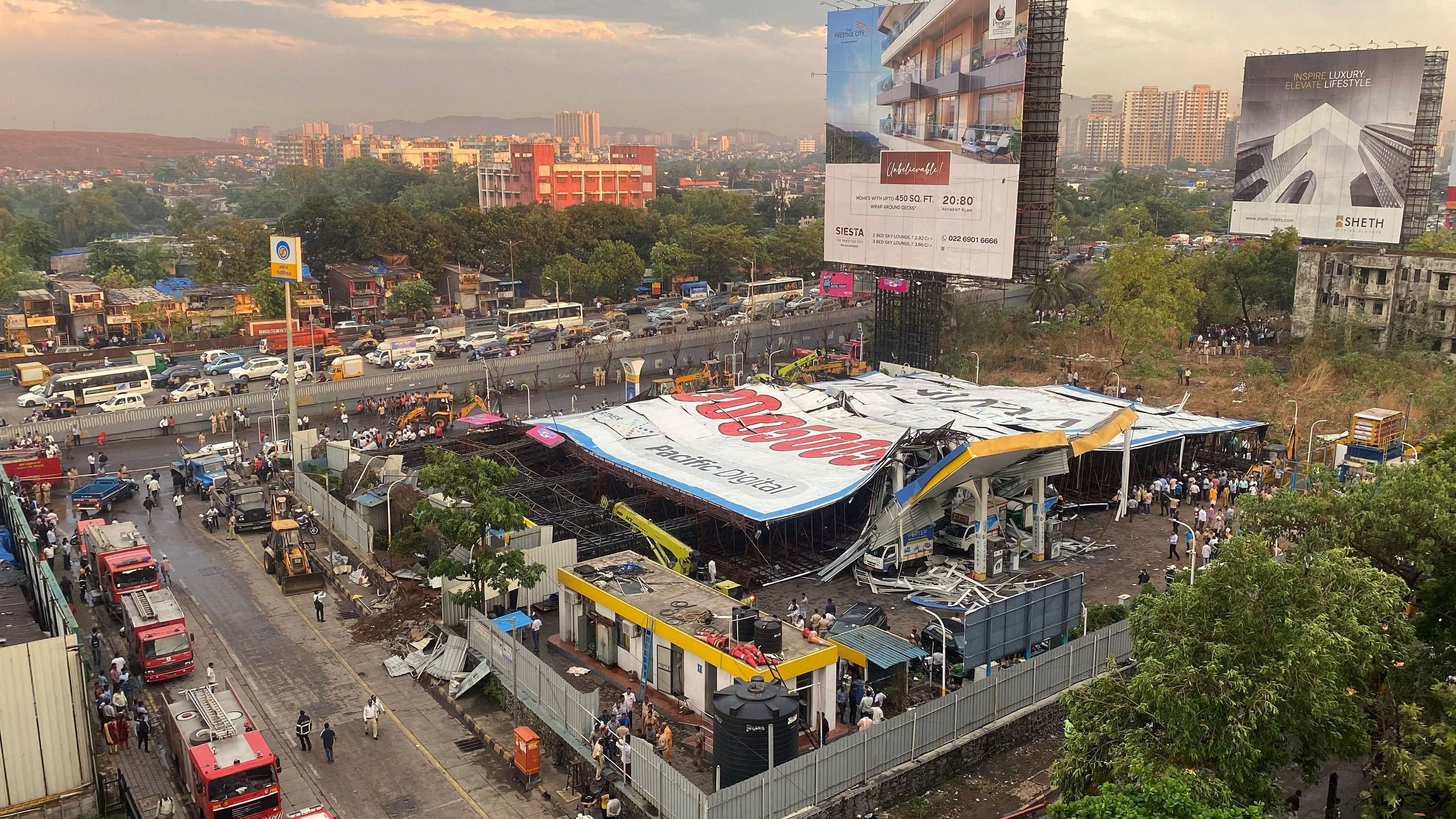 <div class="paragraphs"><p>An aerial view shows a fallen billboard on a fuel station following a wind and dust storm in Mumbai</p></div>