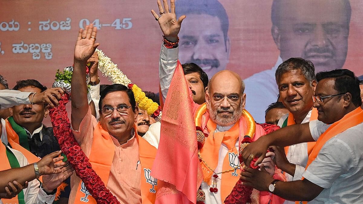 <div class="paragraphs"><p>Union Home Minister Amit Shah with Union Minister and BJP candidate Pralhad Joshi during a public meeting for Lok Sabha elections, in Hubballi.&nbsp;</p></div>