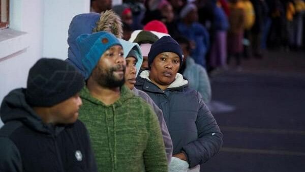 <div class="paragraphs"><p>People queue to vote in the South African elections in Masiphumelele, South Africa, May 29, 2024.</p></div>