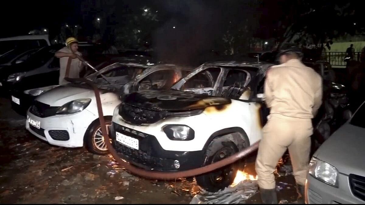 <div class="paragraphs"><p>Firefighter souse flame in vehicles after a fire broke out at a civic authority-run parking lot in Madhu Vihar area of east Delhi, late Tuesday night.</p></div>