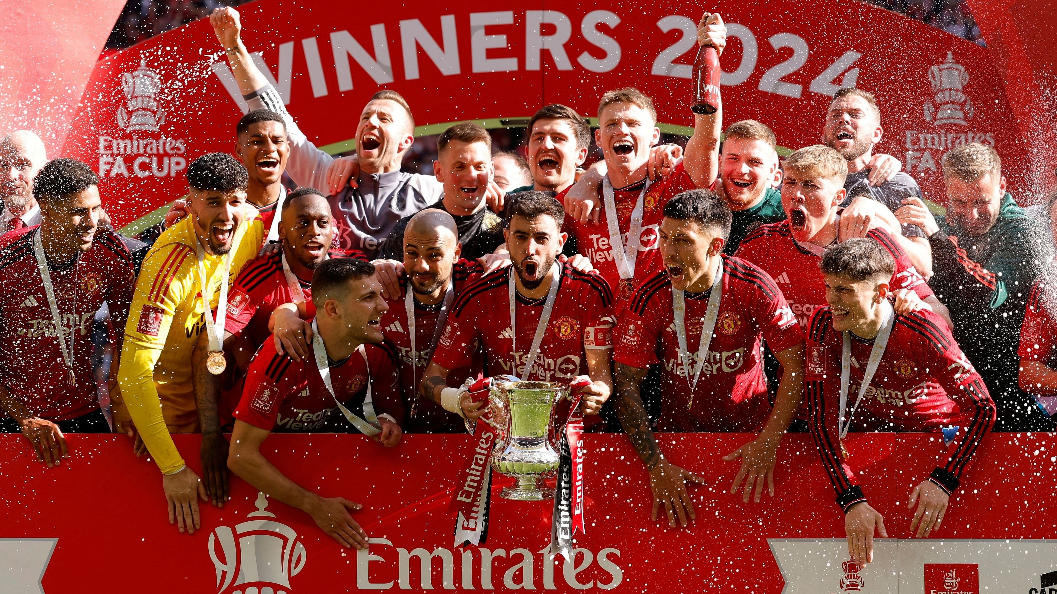 <div class="paragraphs"><p>Manchester United's Bruno Fernandes celebrates with the trophy and teammates after winning the FA Cup.</p></div>