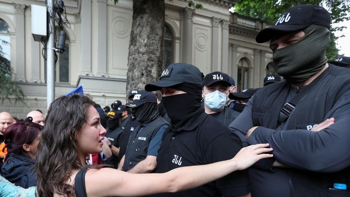 <div class="paragraphs"><p>Demonstrators stand in front of law enforcement officers during a rally to protest against a bill on "foreign agents", after Georgia's parliament voted to override a presidential veto of the bill.</p></div>