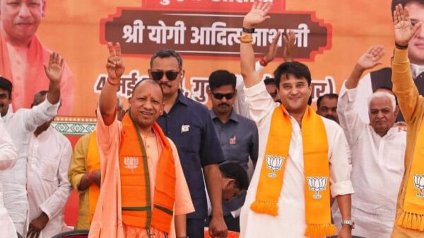 <div class="paragraphs"><p>Uttar Pradesh Chief Minister Yogi Adityanath and Union Minister Jyotiraditya Scindia wave to supporters during a public meeting for the Lok Sabha elections, in Guna.</p></div>