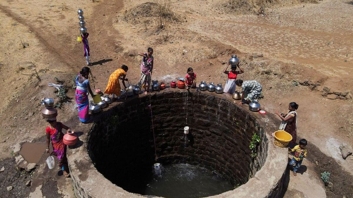 <div class="paragraphs"><p>A drone view of women drawing water from a well on a hot day in Kasara</p><p></p></div>